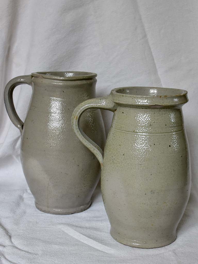 Two antique French milk pitchers - gray sandstone