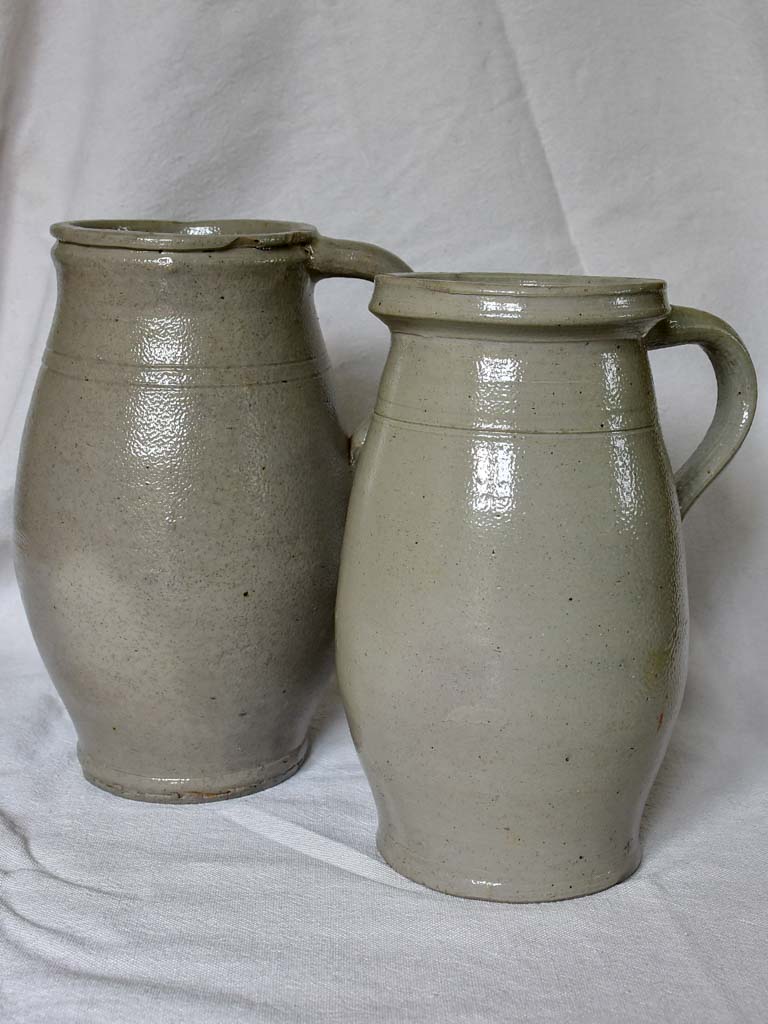 Two antique French milk pitchers - gray sandstone