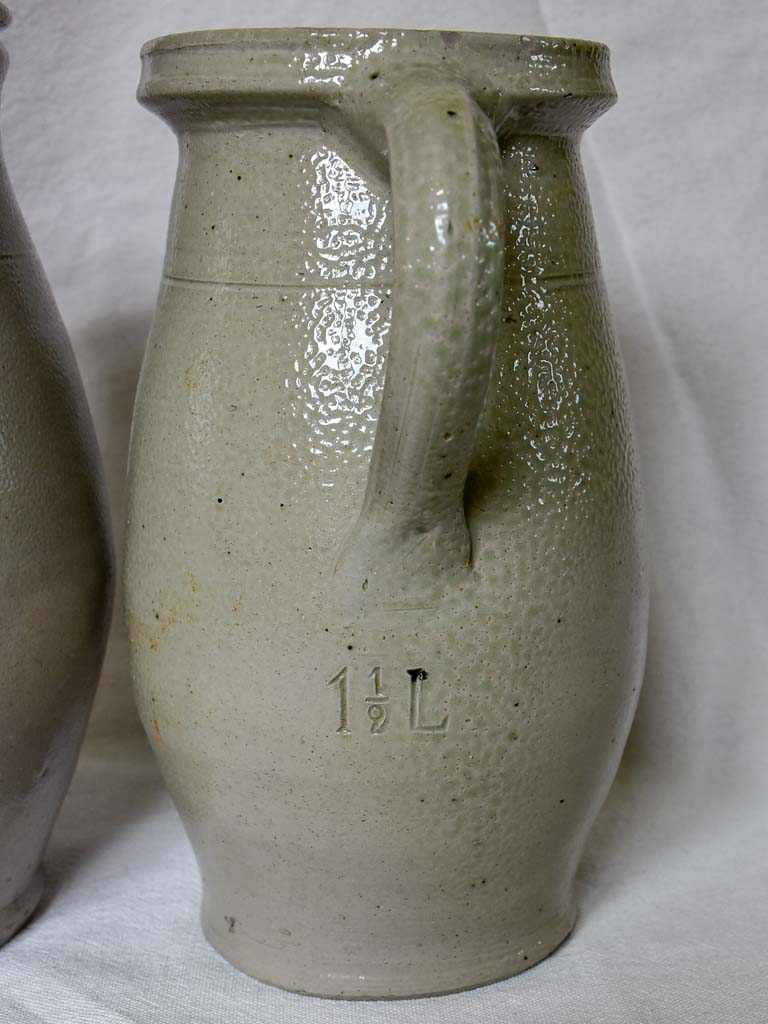 Two antique French milk pitchers - gray sandstone