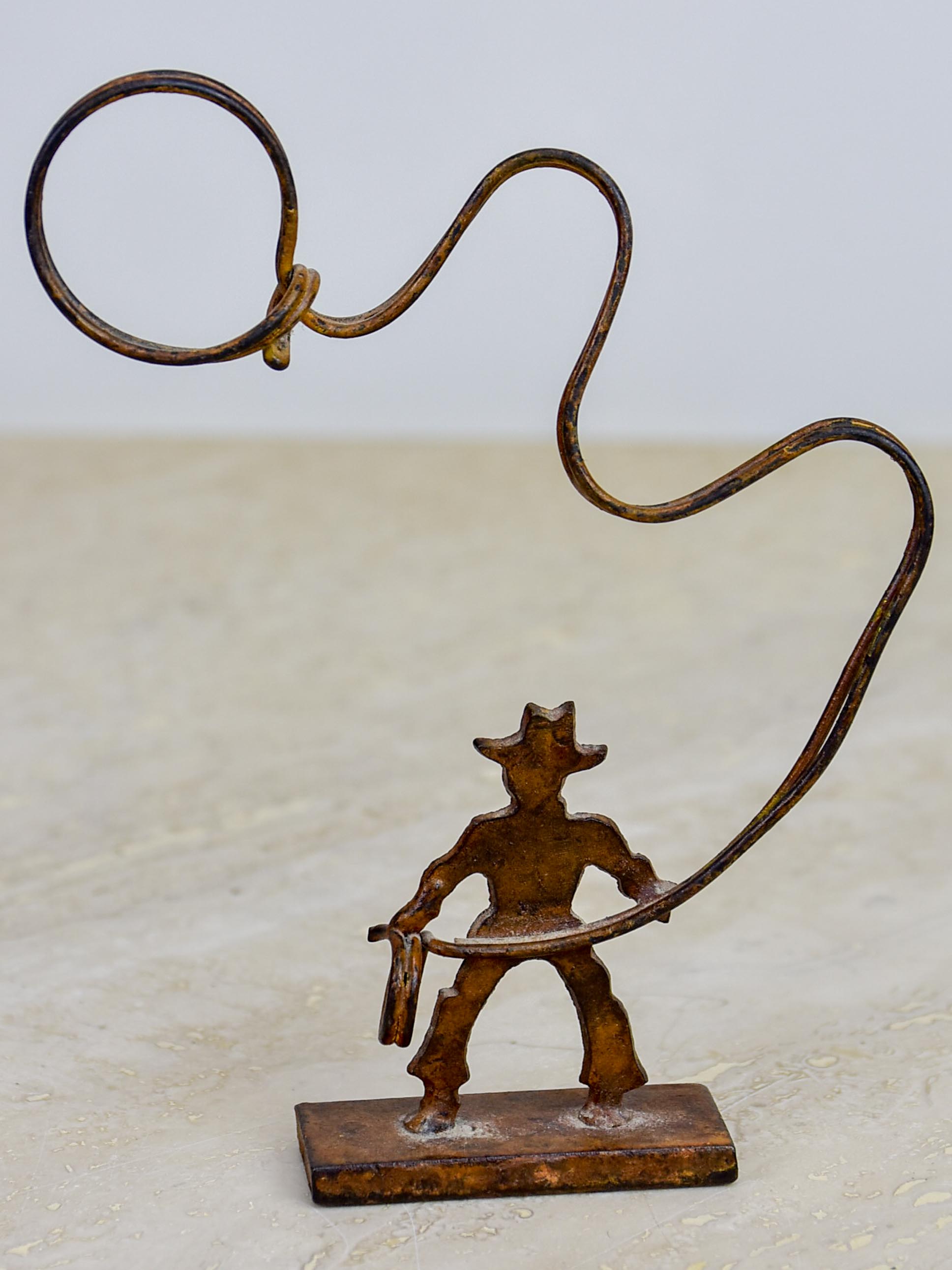 Antique cowboy lasso sculpture