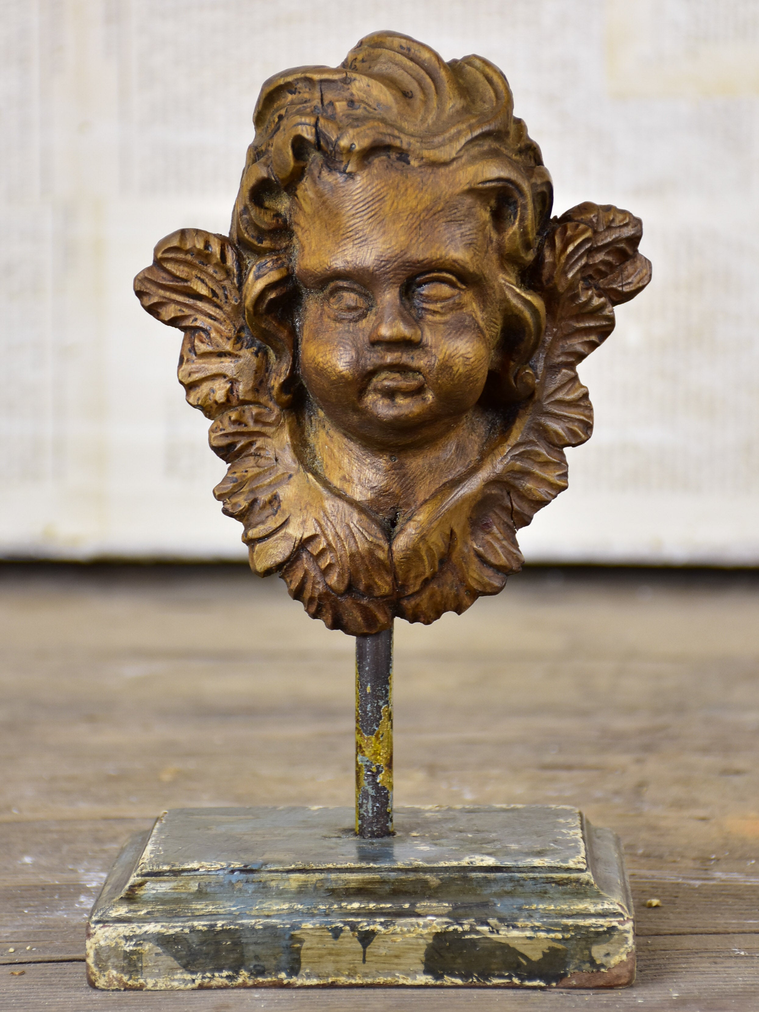 Small antique carved angel mounted on a stand