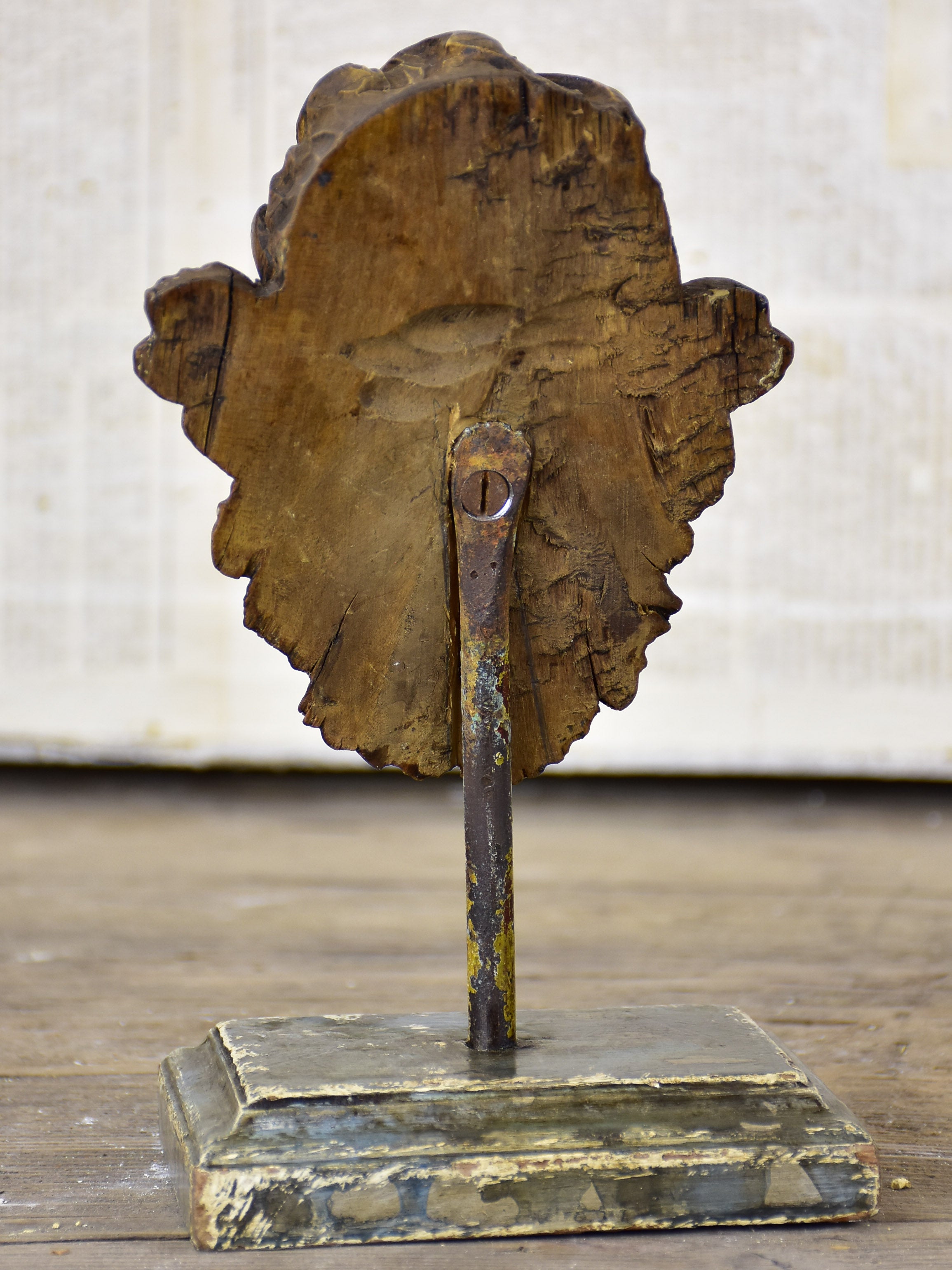 Small antique carved angel mounted on a stand