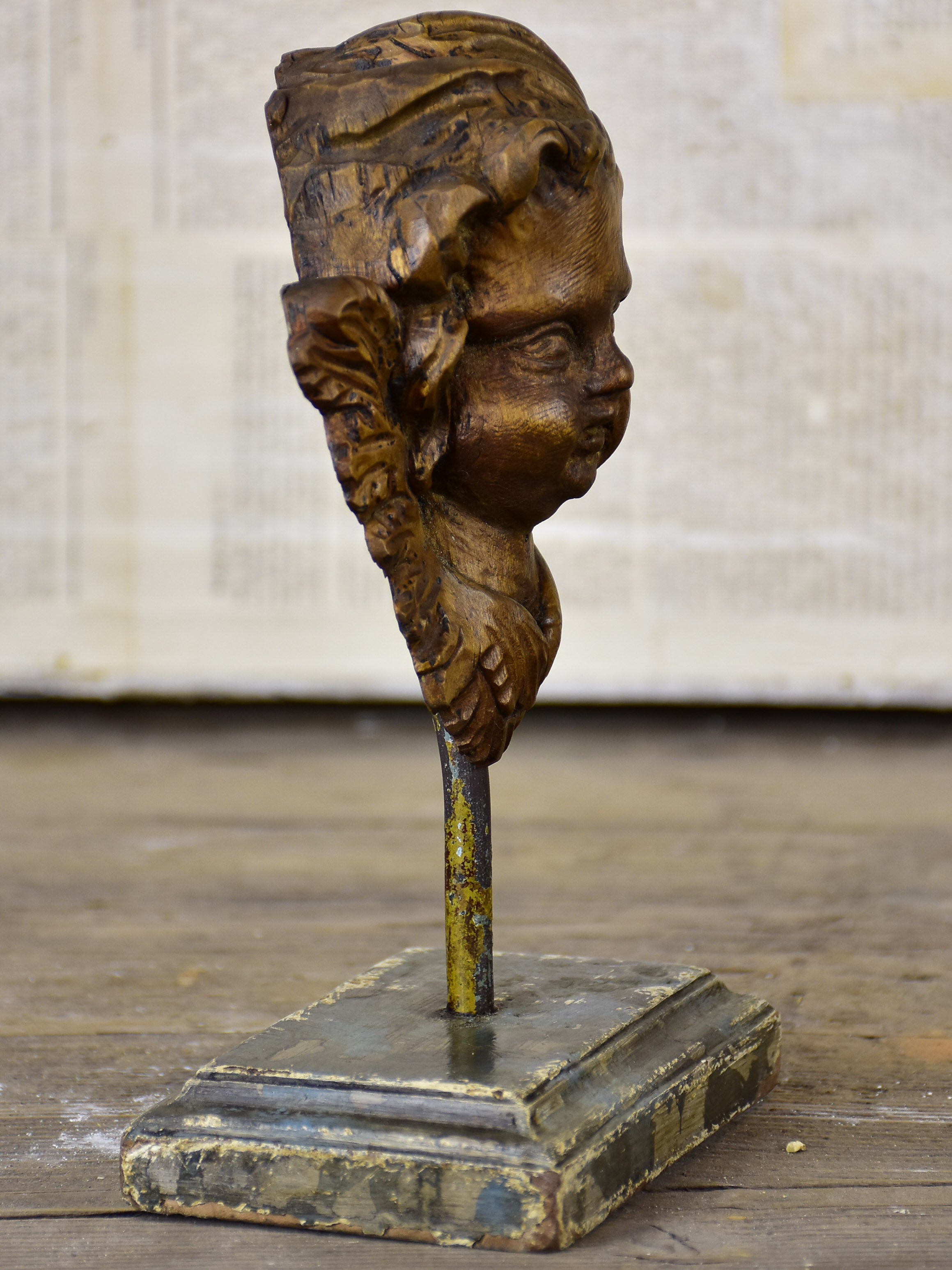 Small antique carved angel mounted on a stand