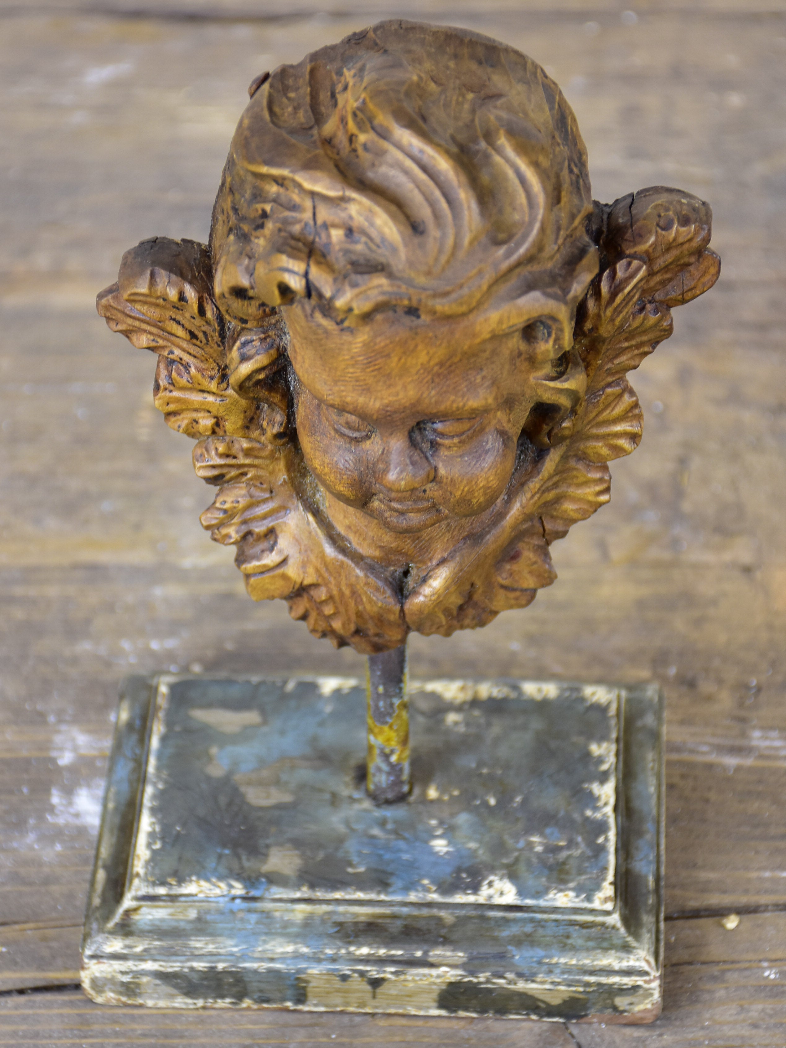 Small antique carved angel mounted on a stand