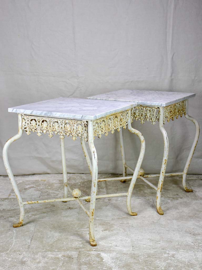 Pair of white cast iron and Carrara marble side tables