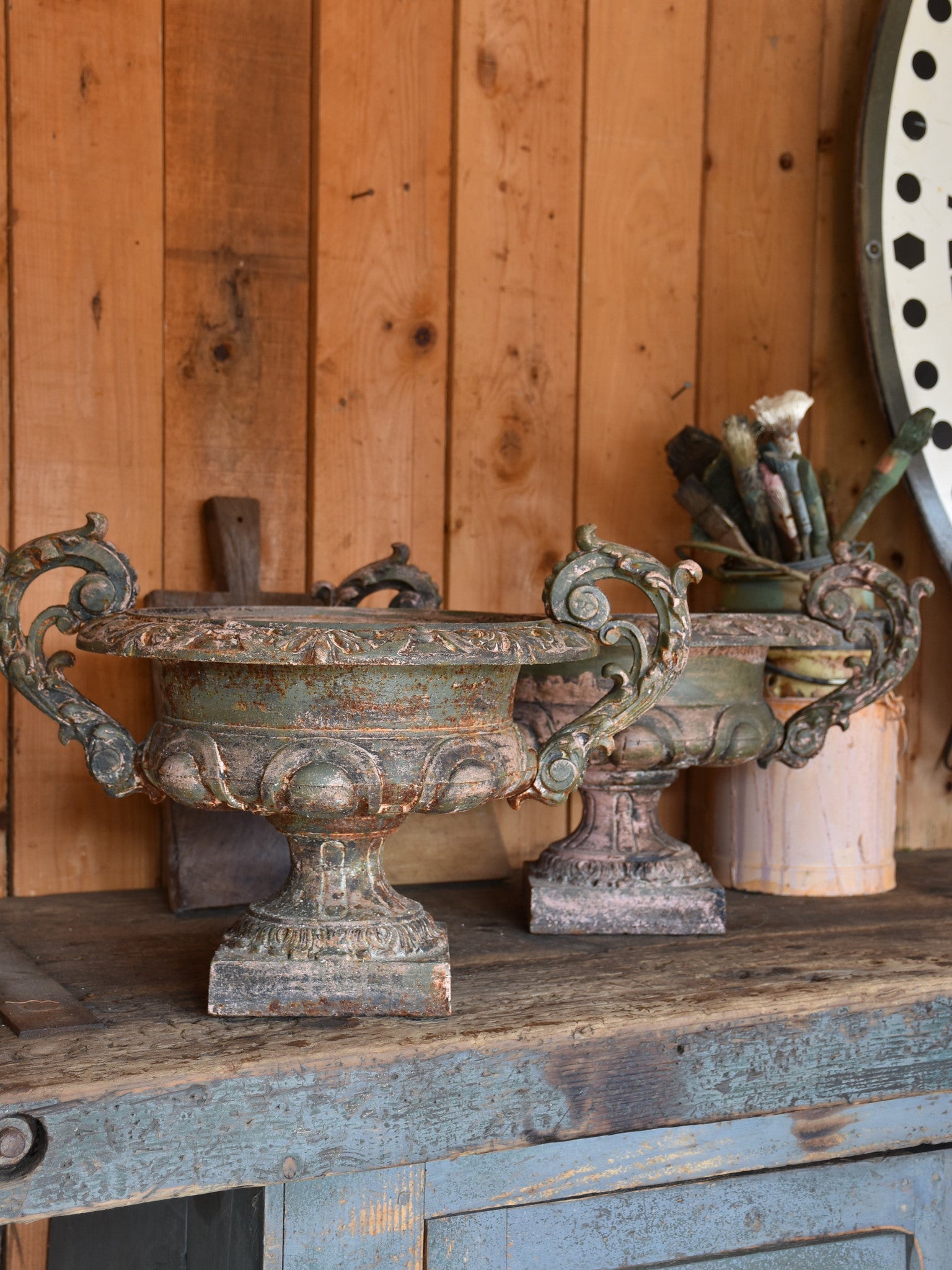 Pair of antique Medici urns with green / pink patina