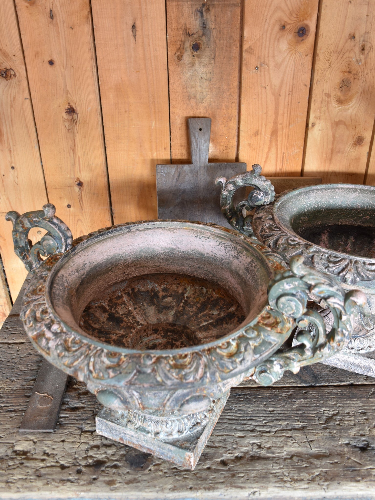 Pair of antique Medici urns with green / pink patina