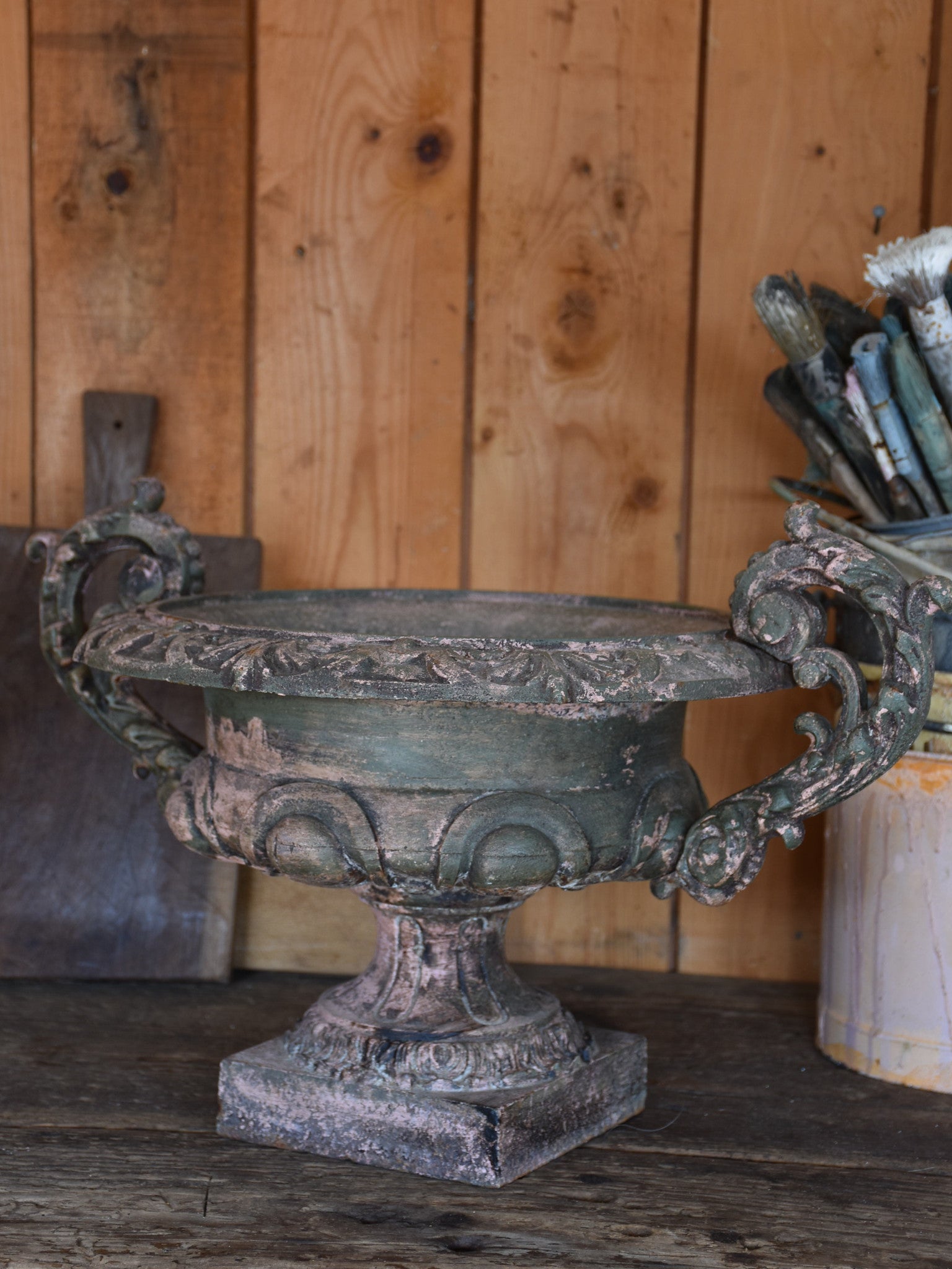 Pair of antique Medici urns with green / pink patina