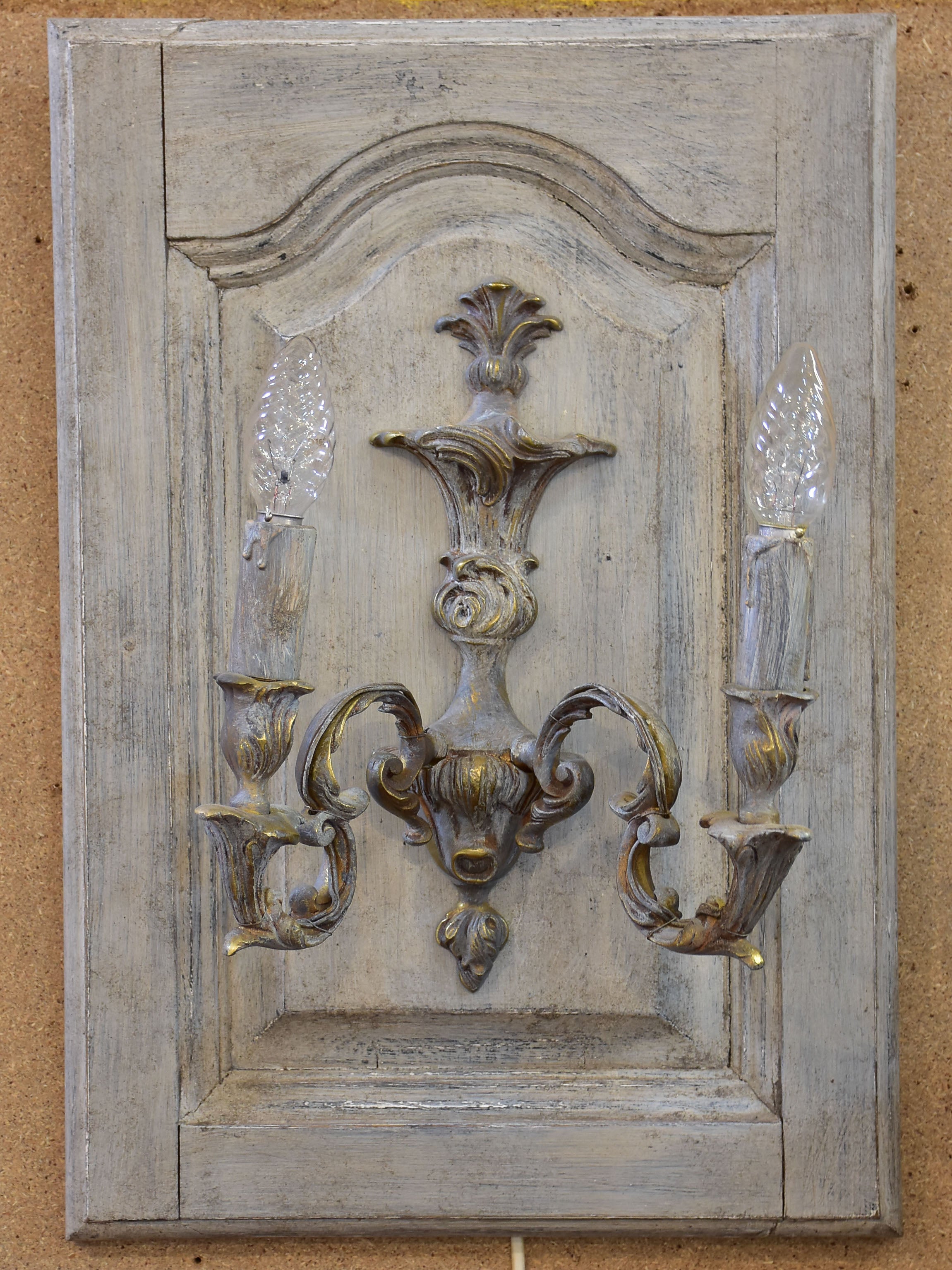 Pair of vintage French wall sconces mounted on salvaged doors