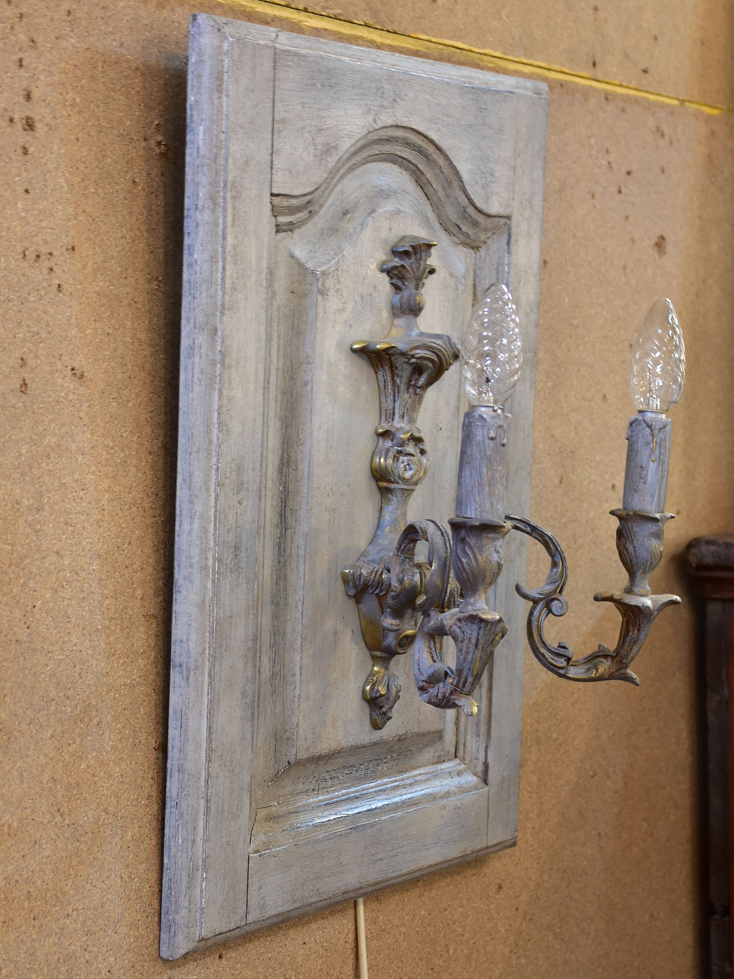 Pair of vintage French wall sconces mounted on salvaged doors