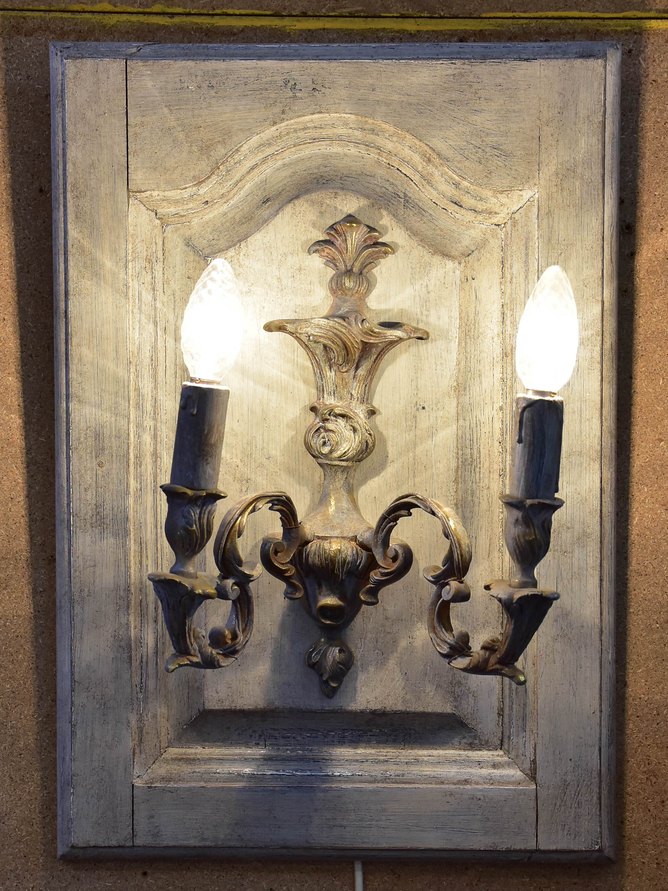 Pair of vintage French wall sconces mounted on salvaged doors