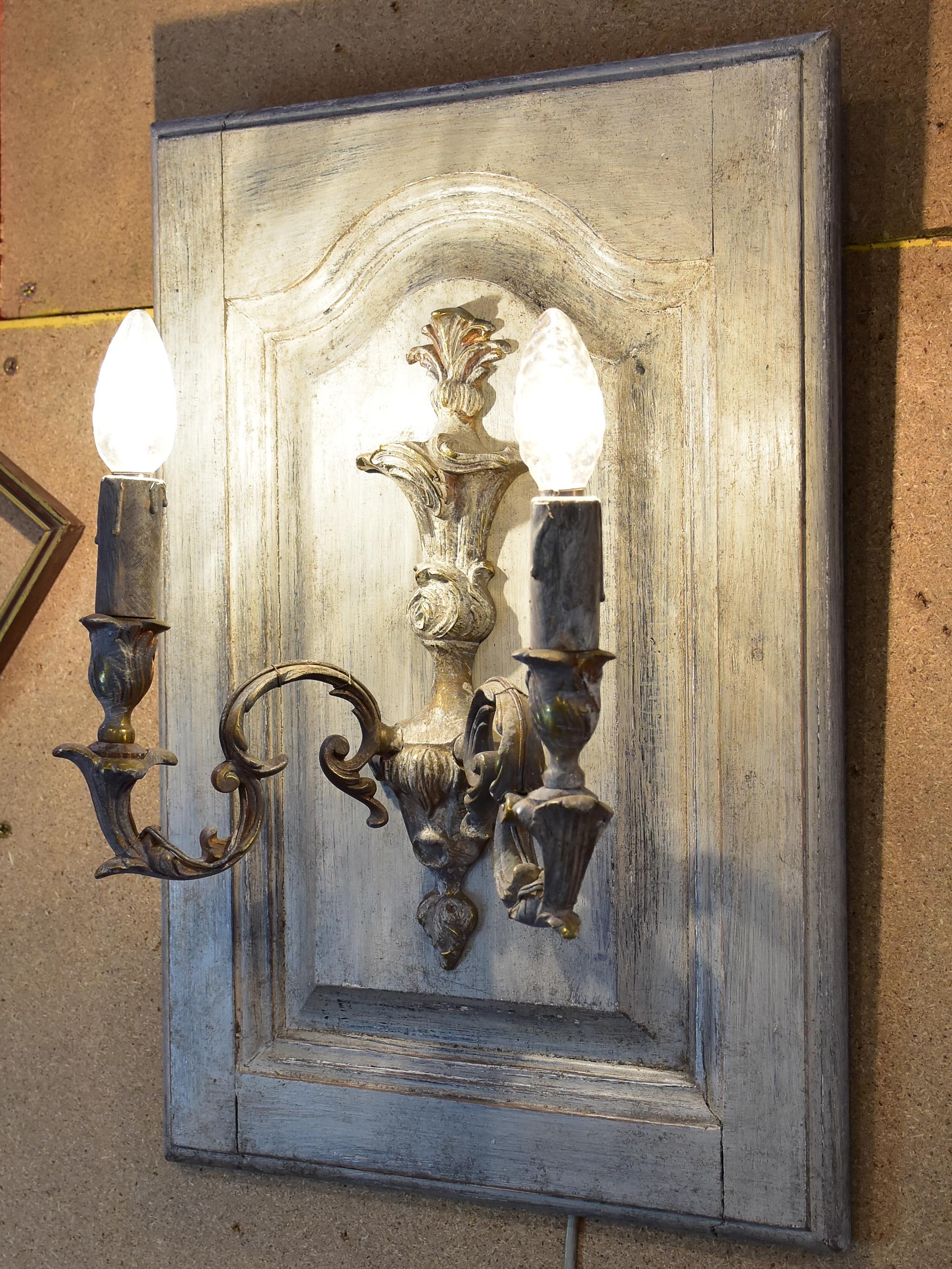 Pair of vintage French wall sconces mounted on salvaged doors