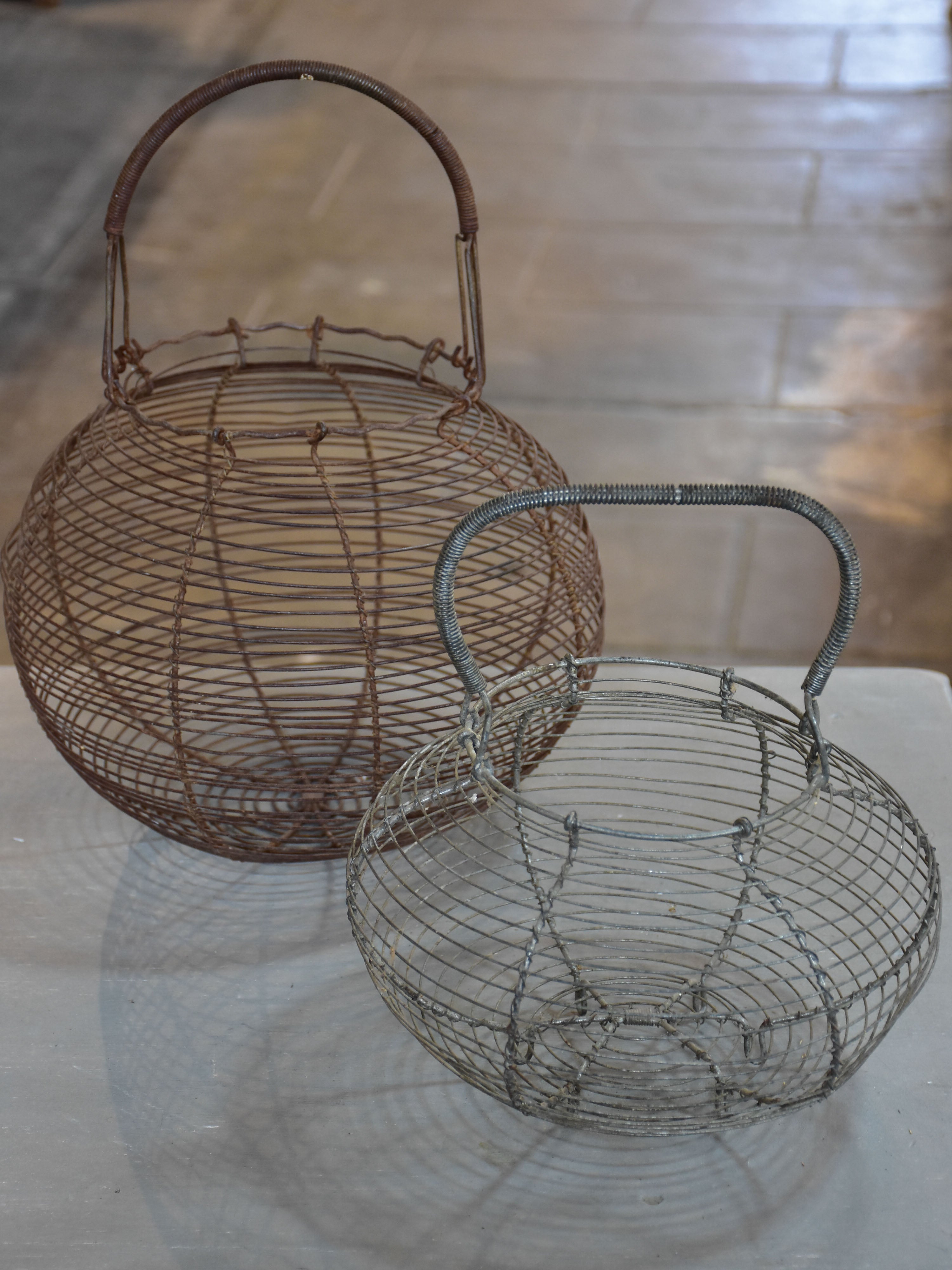 Two antique French wire baskets