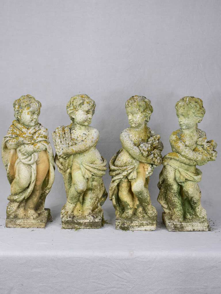 Collection of four vintage cherubs representing the four seasons - weathered patina 19¼"