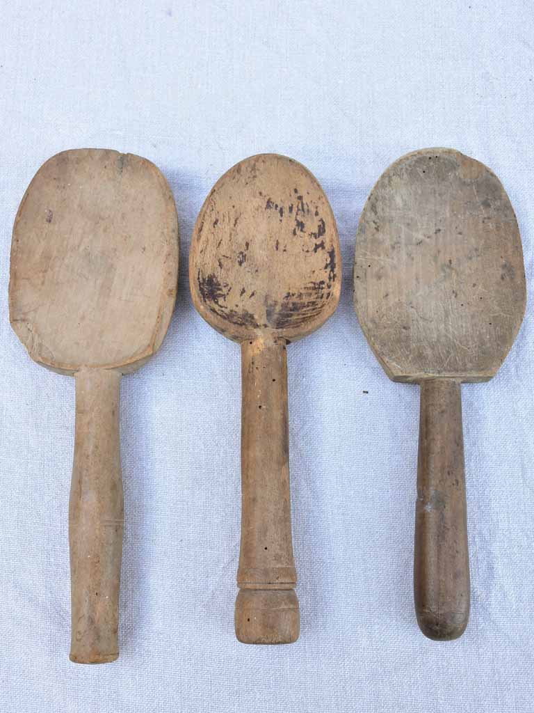 Two primitive wooden cream bowls with three spoons from Angers