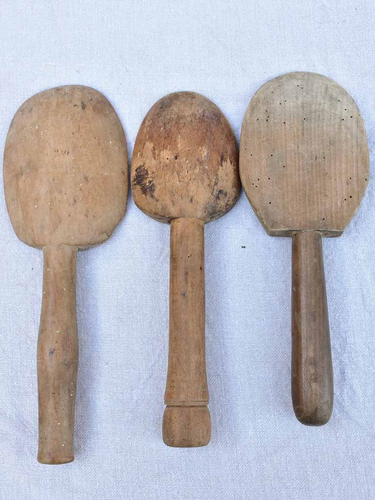 Two primitive wooden cream bowls with three spoons from Angers