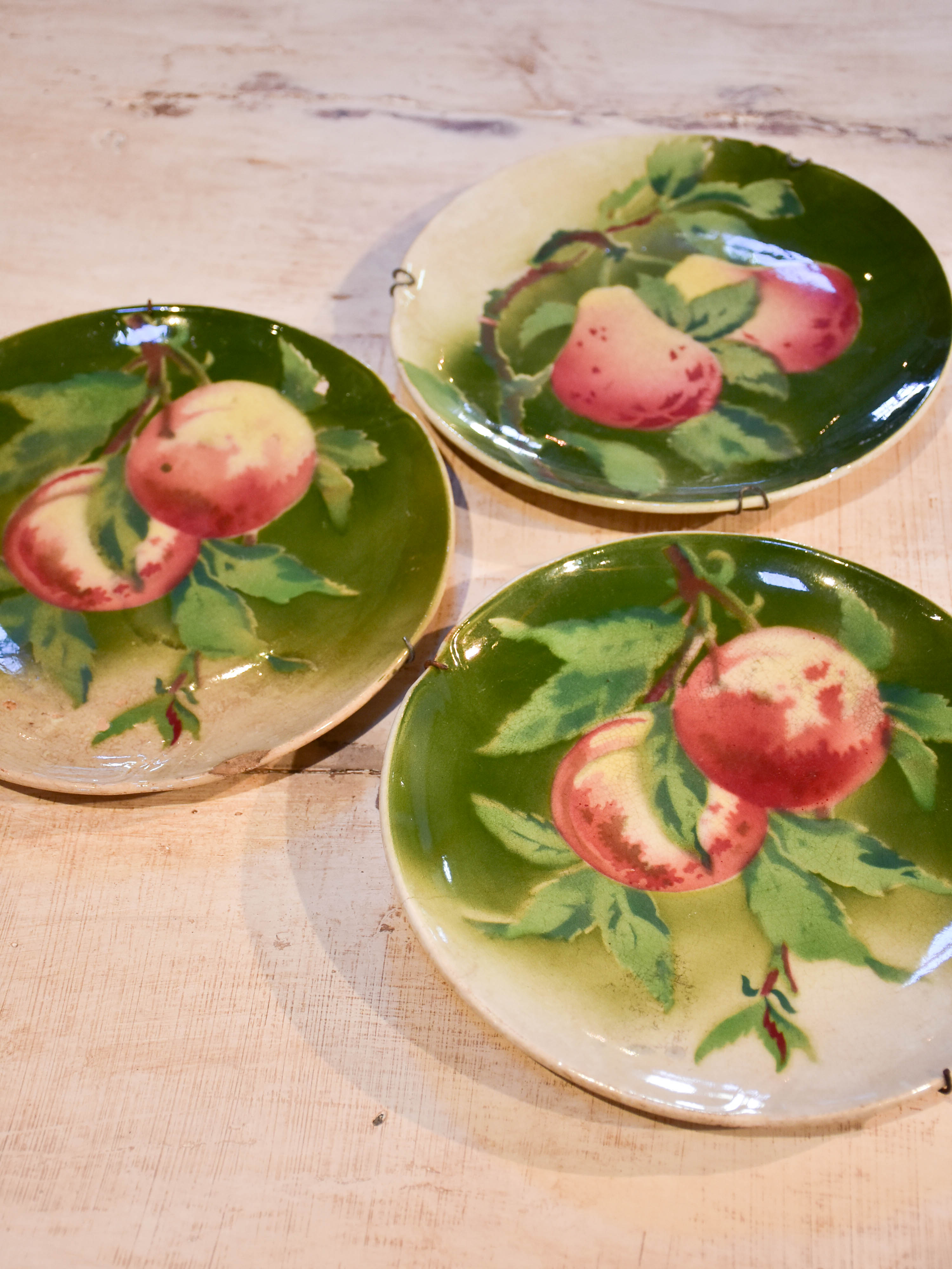 Three antique Gien plates with fruit