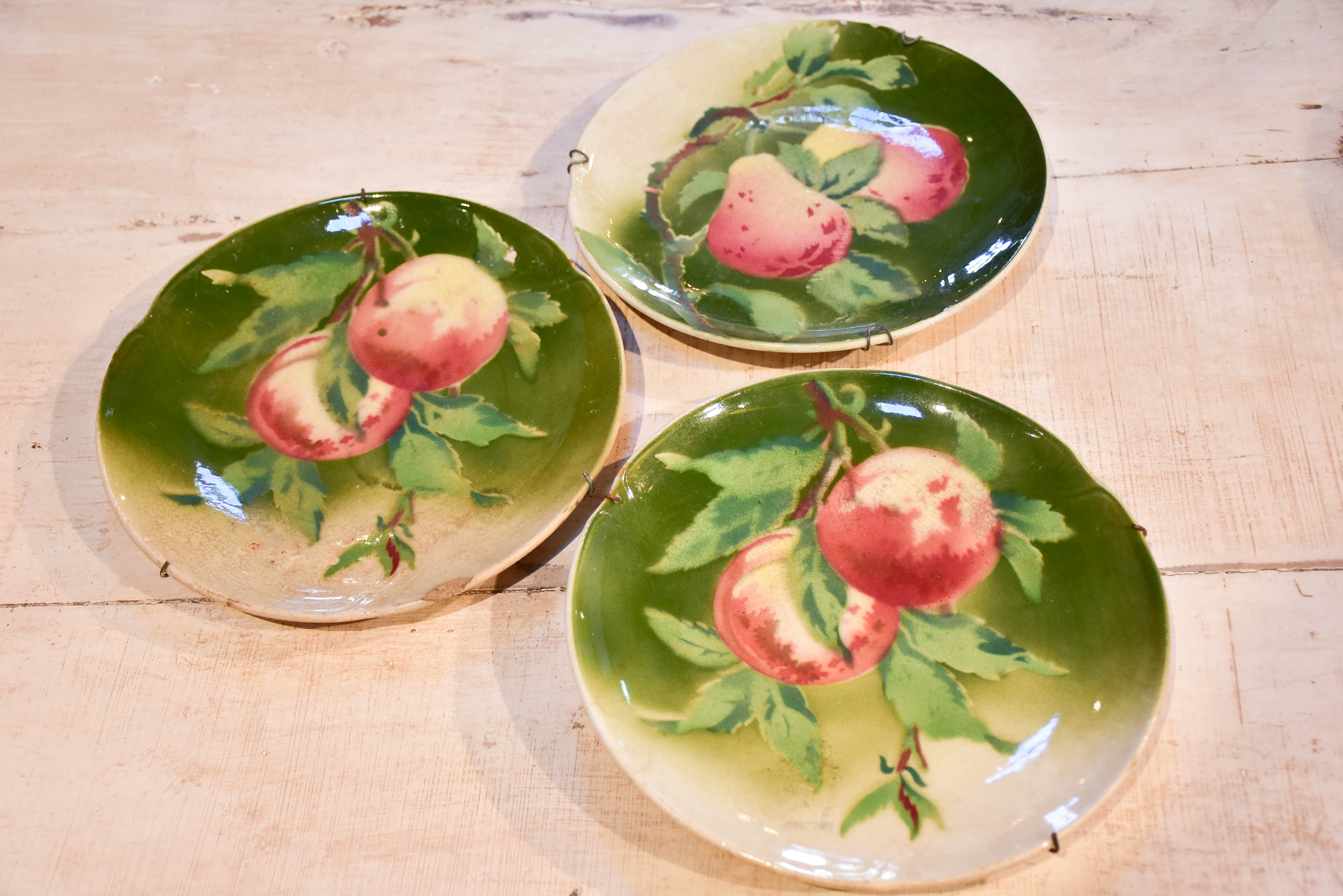 Three antique Gien plates with fruit