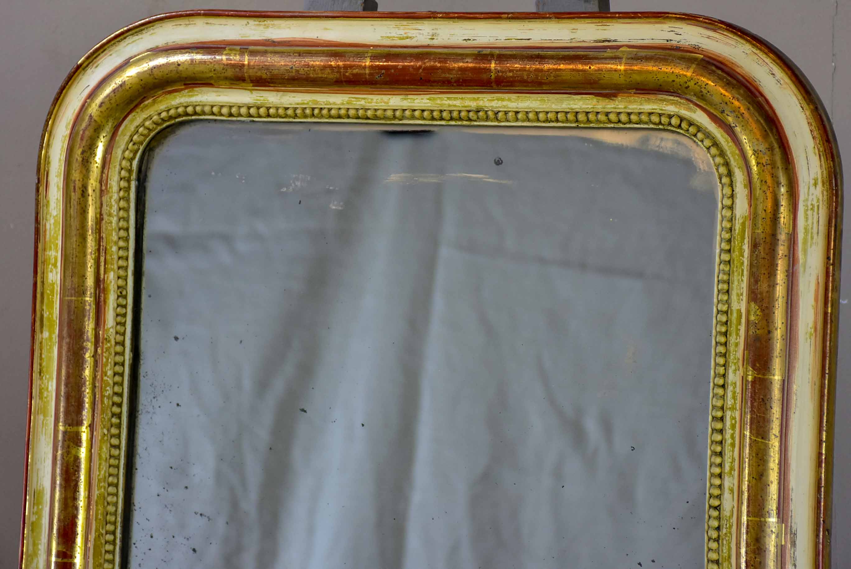 Rustic antique French Louis Philippe mirror with timeworn gilded frame