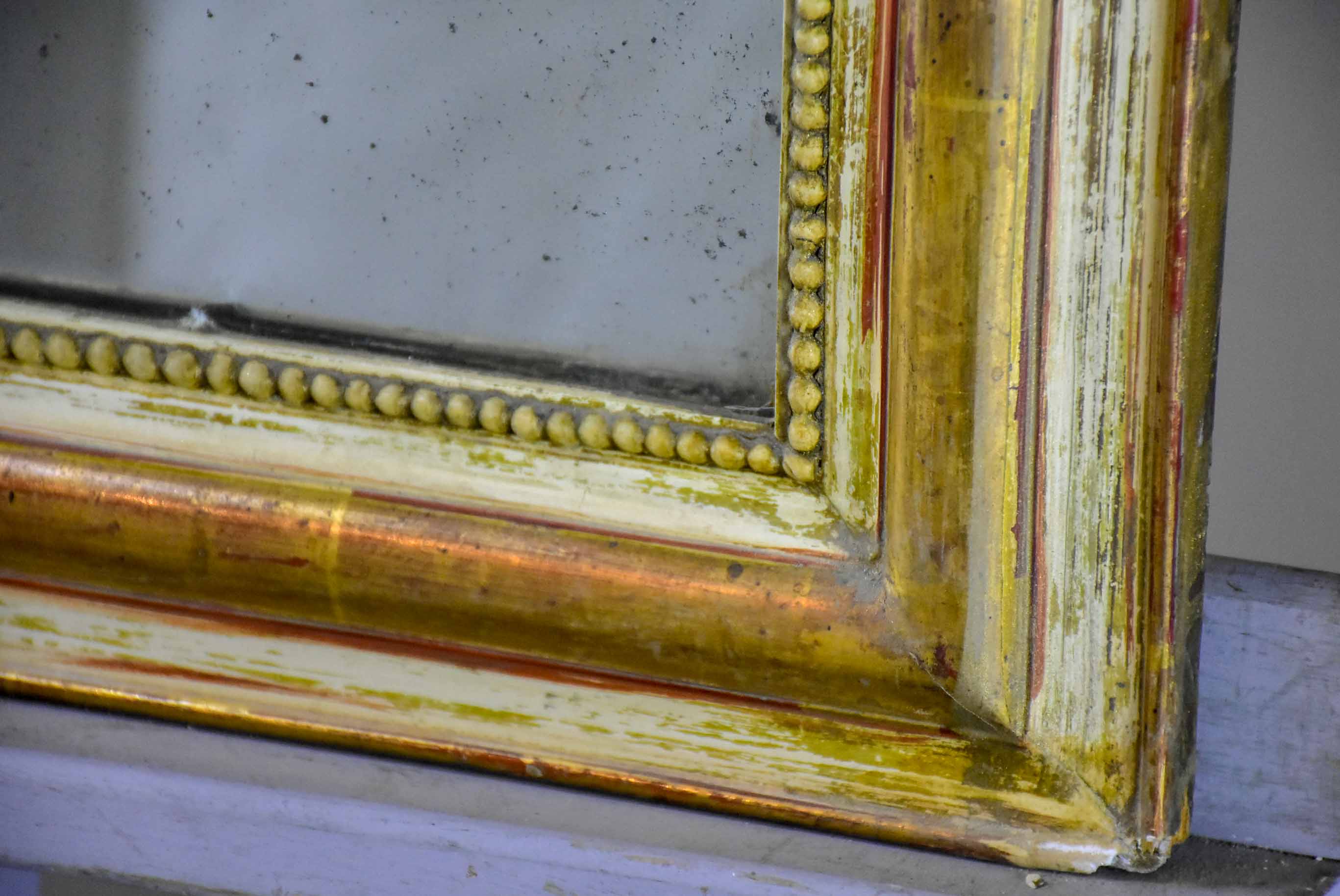 Rustic antique French Louis Philippe mirror with timeworn gilded frame