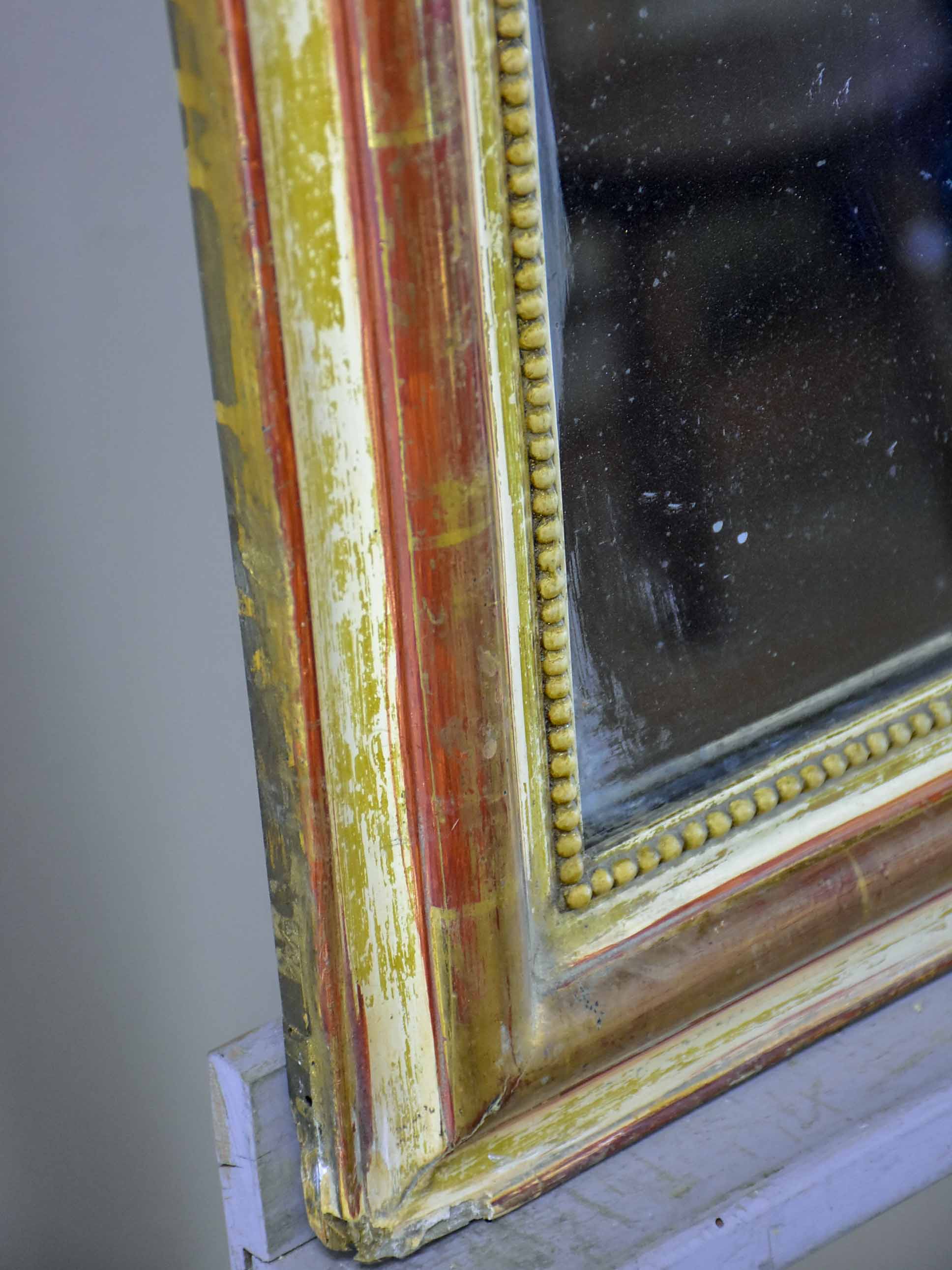 Rustic antique French Louis Philippe mirror with timeworn gilded frame