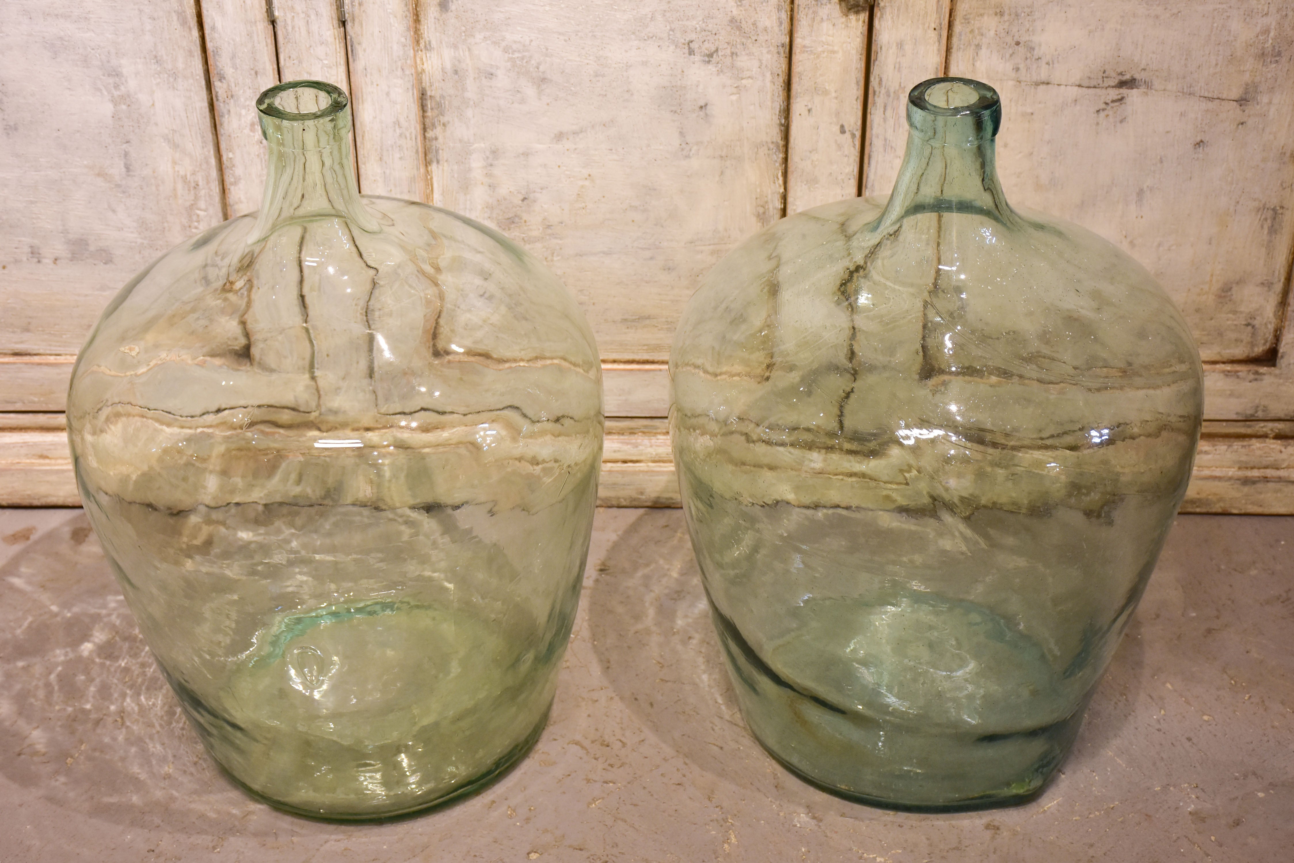 Pair of antique demijohn bottles