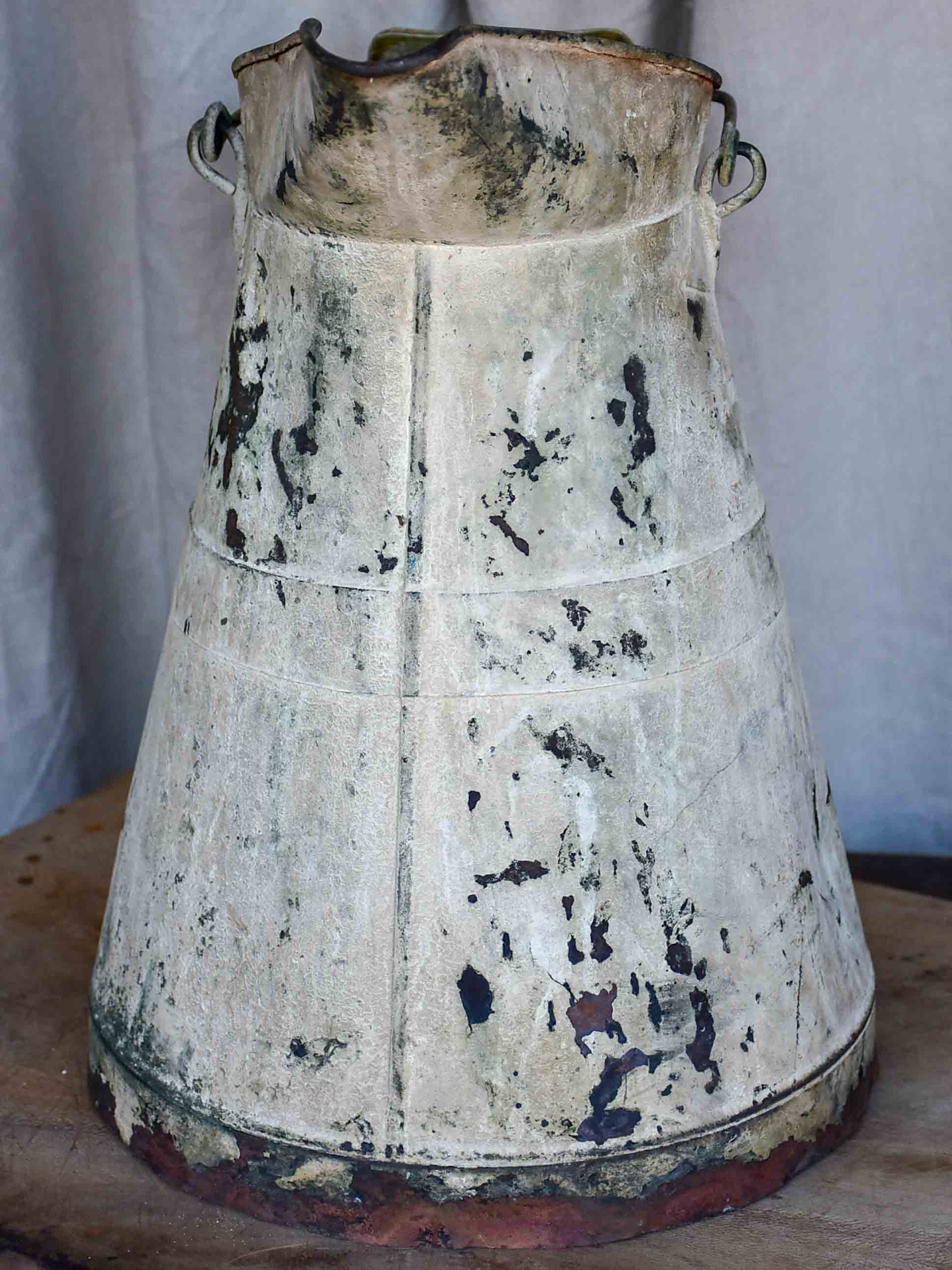 Antique French watering can with beige patina