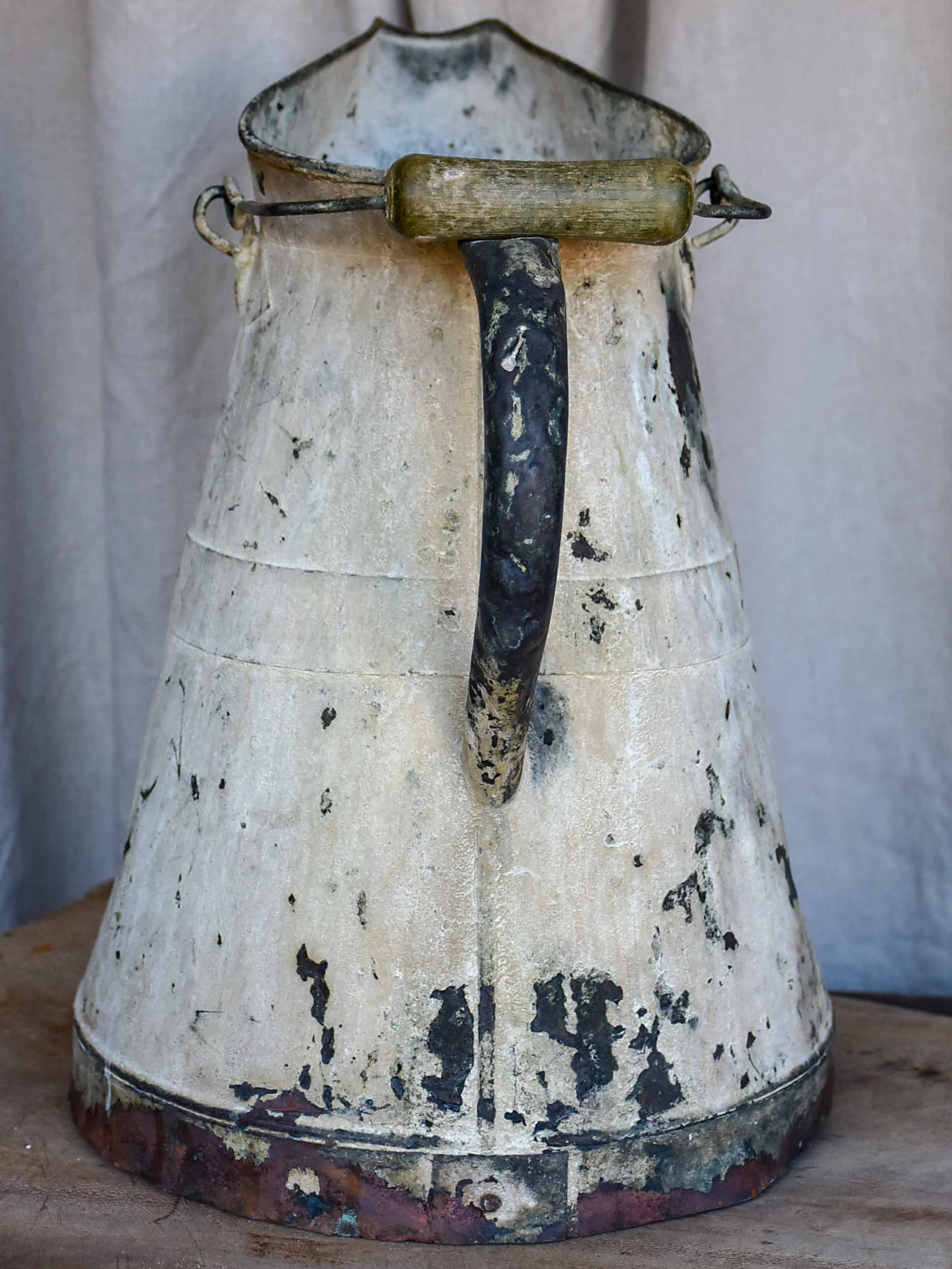 Antique French watering can with beige patina