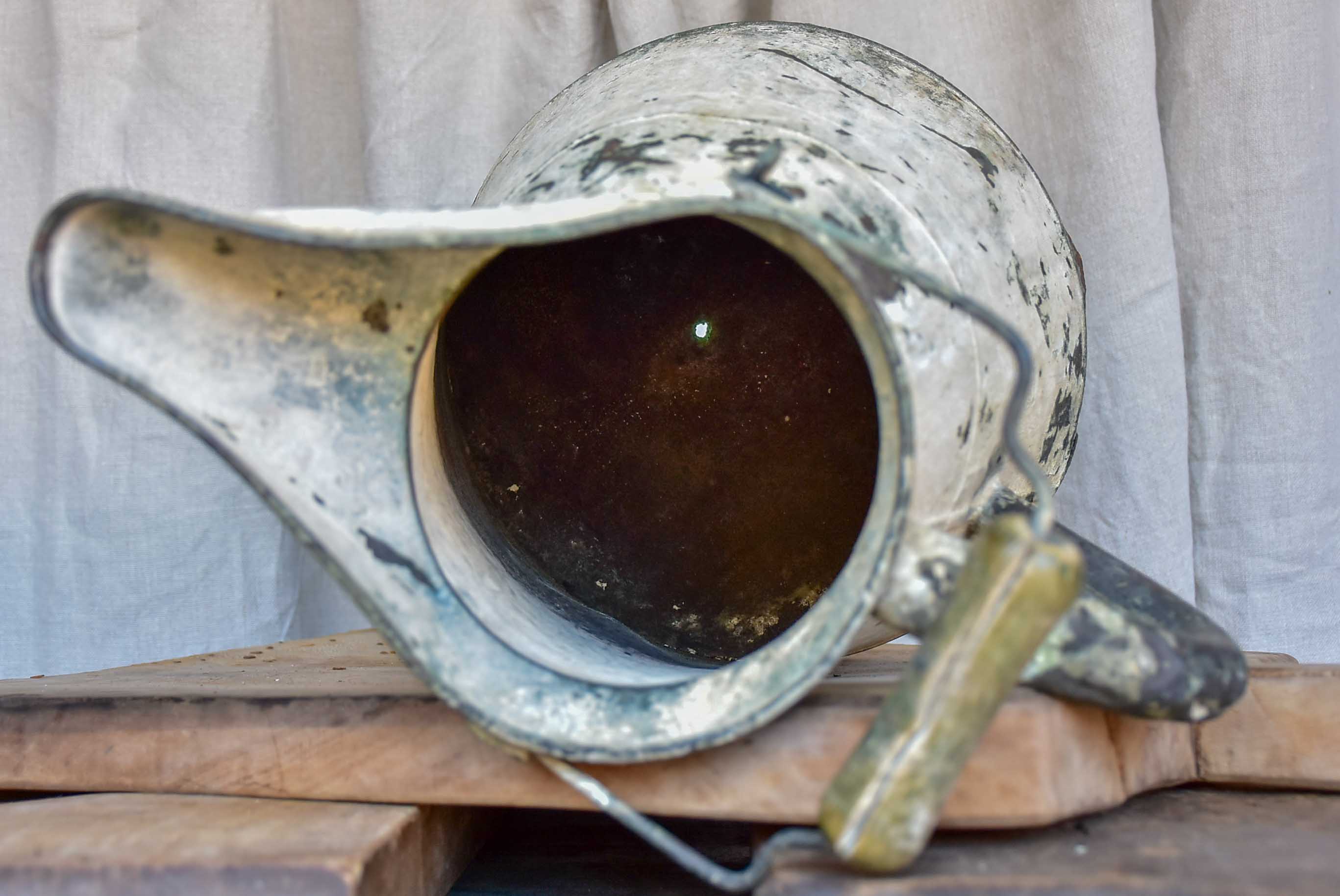 Antique French watering can with beige patina