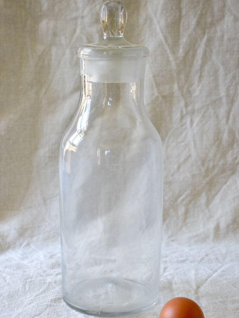 Antique French apothecary glass bottle with lid