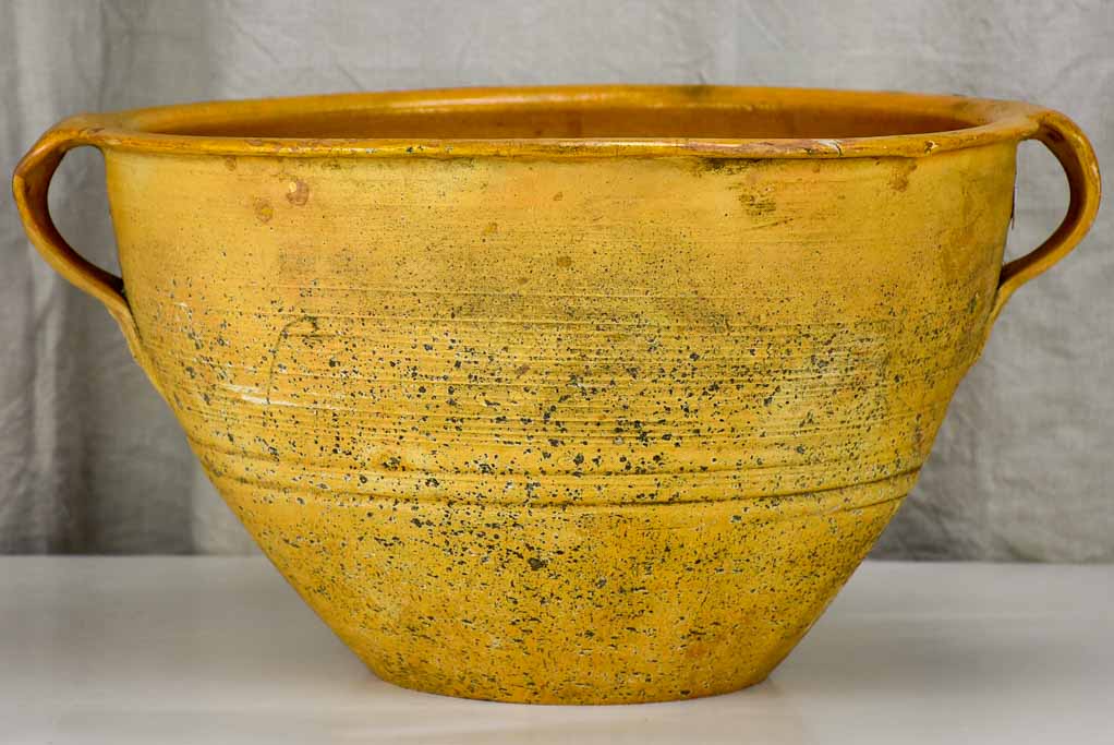 Very large antique Spanish bowl with orange glaze