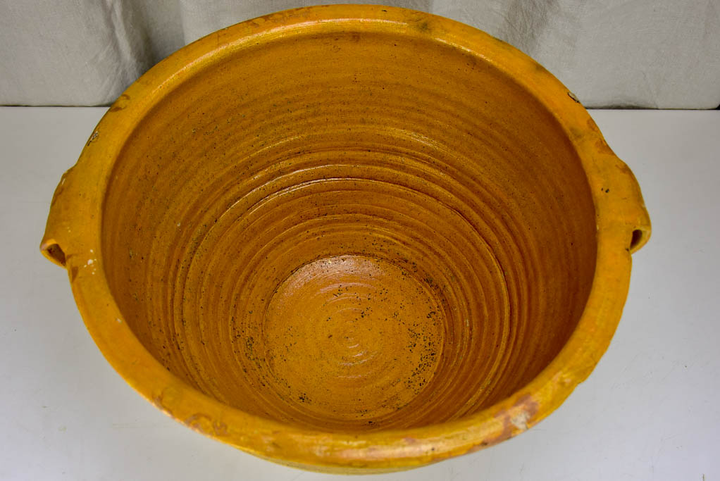 Very large antique Spanish bowl with orange glaze