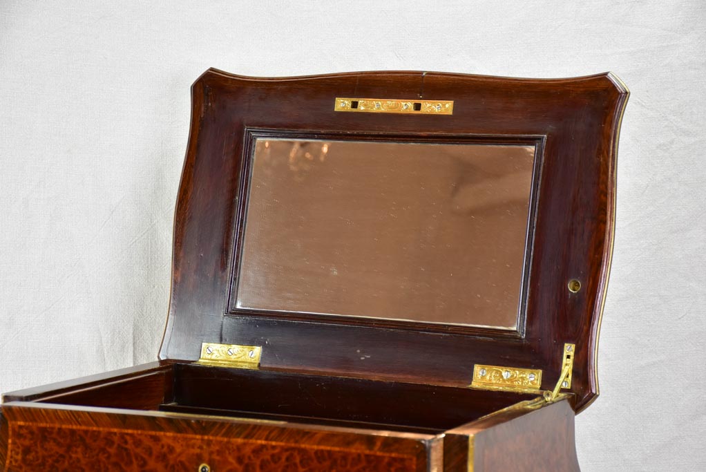 Brass-inlaid monogram on vanity table