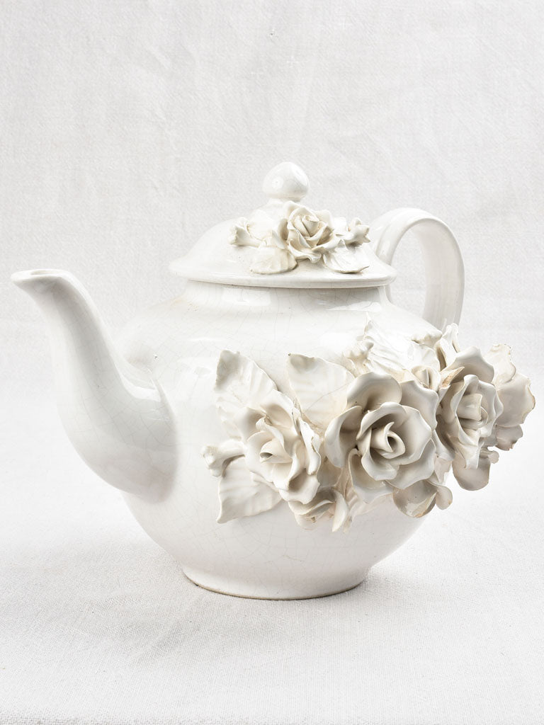 Vintage teapot decorated with sculptural flowers