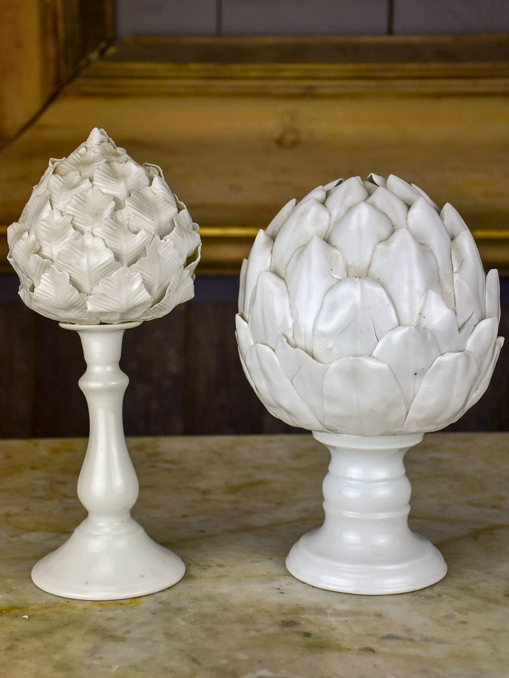 Two antique earthenware mounted artichoke sculptures