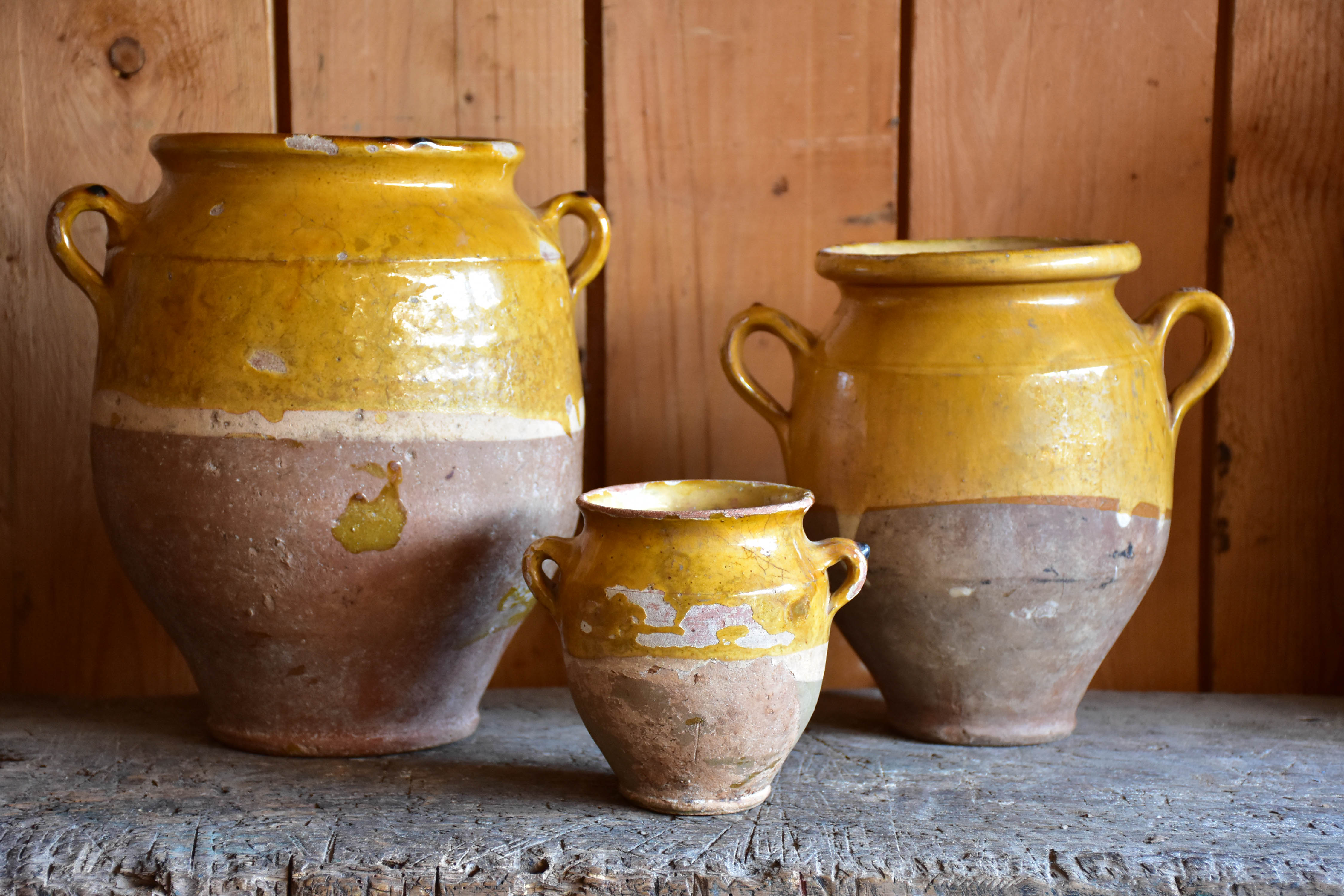 Three antique French confit pots with orange glaze