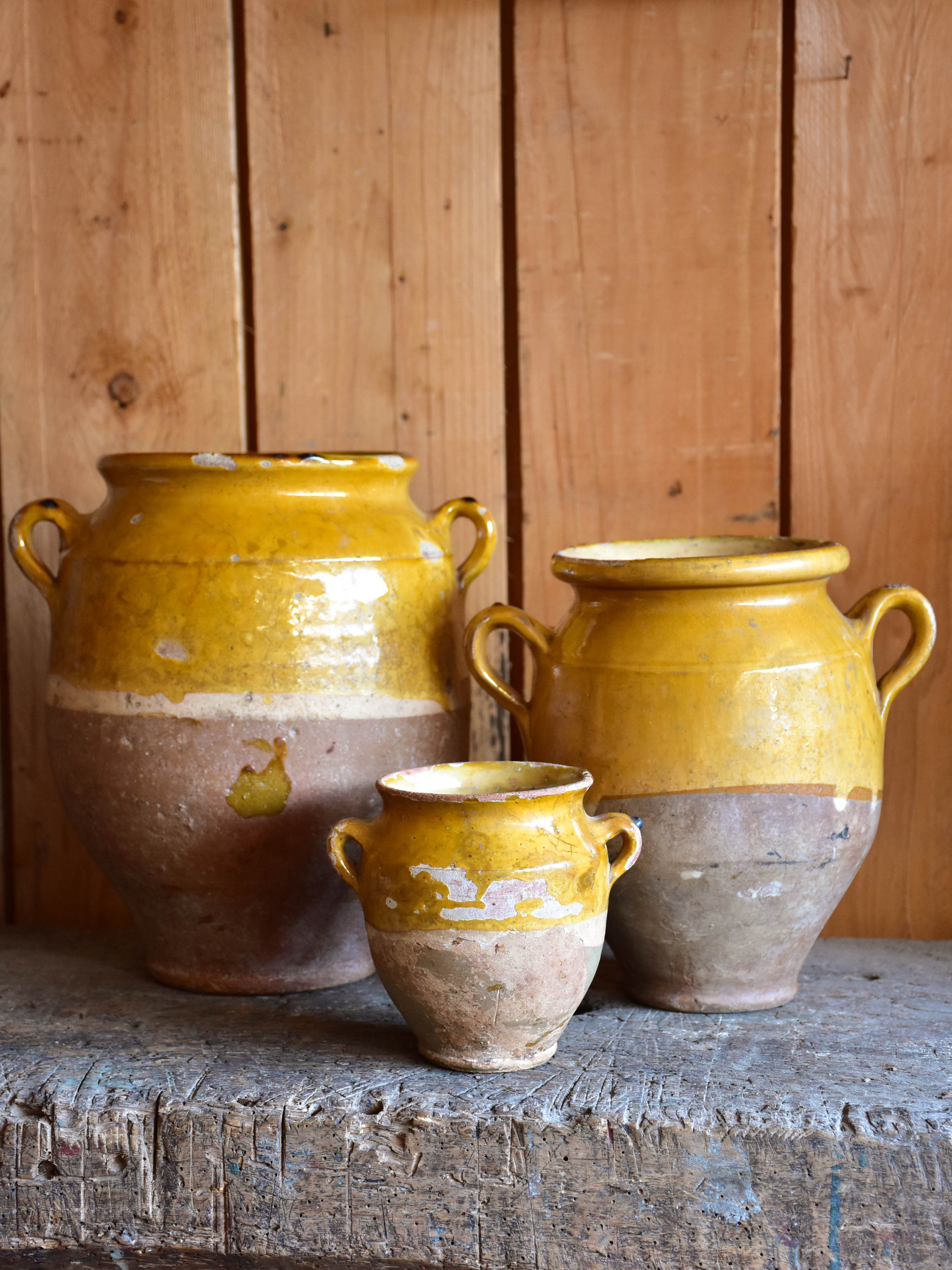 Three antique French confit pots with orange glaze