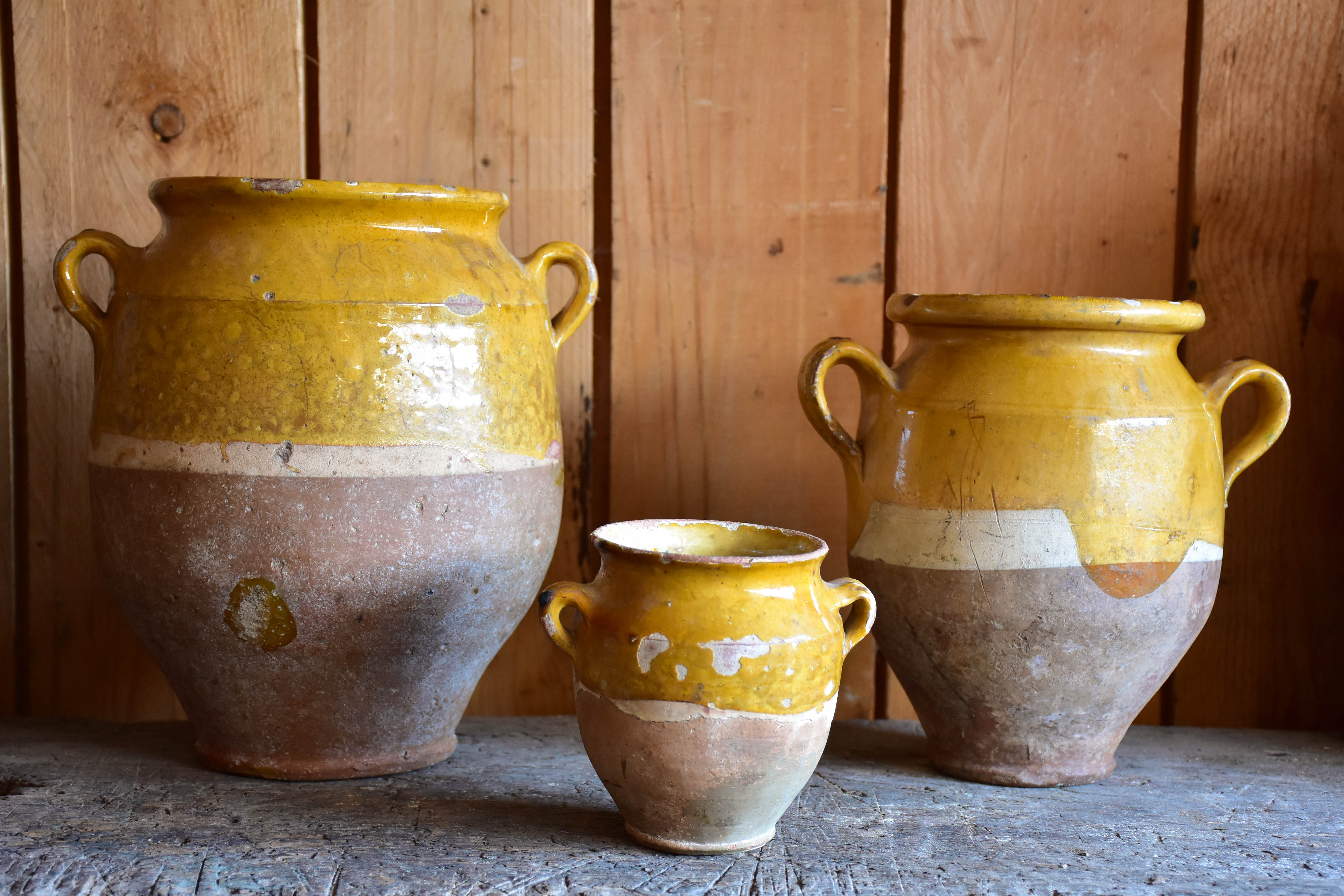 Three antique French confit pots with orange glaze