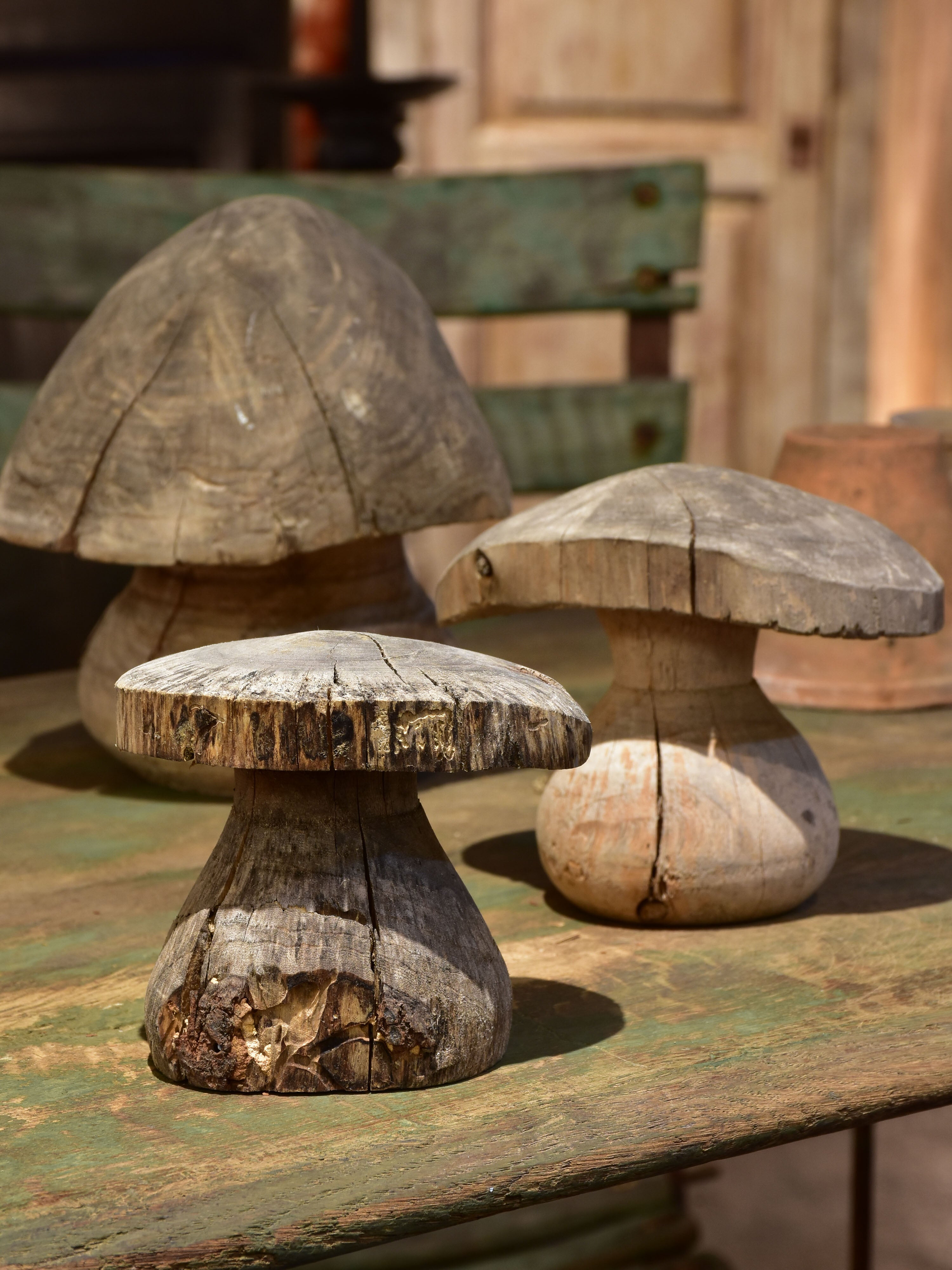 Three wooden French sculptures in the shape of mushrooms