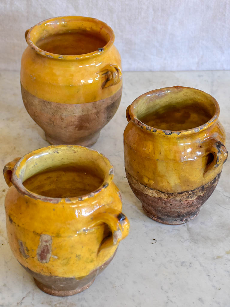 Collection of three very small antique French confit pots with ochre glaze