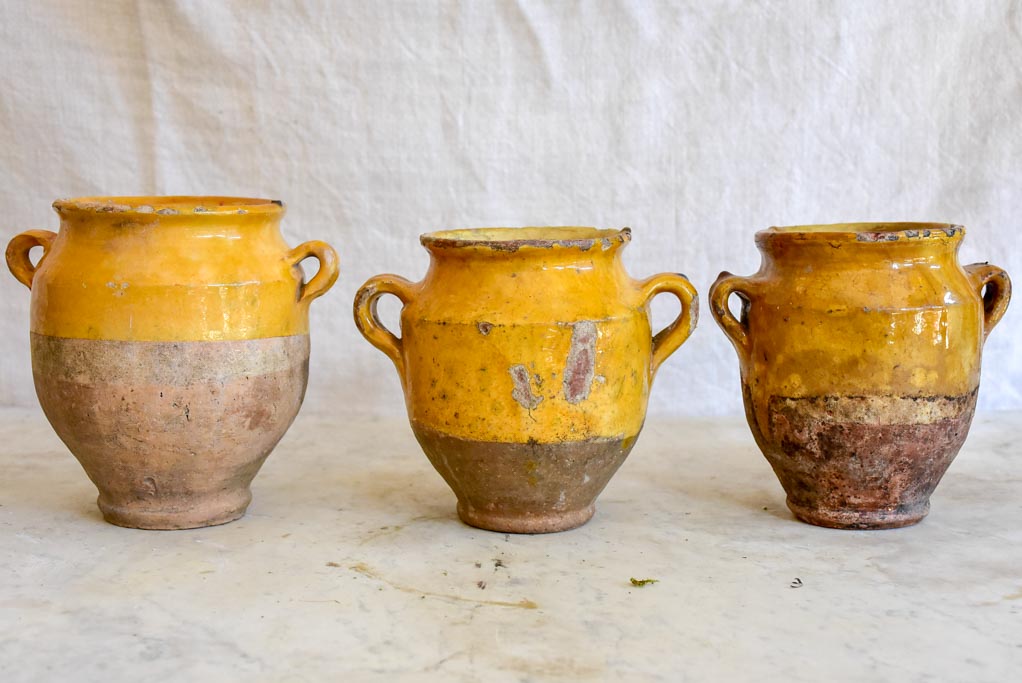 Collection of three very small antique French confit pots with ochre glaze