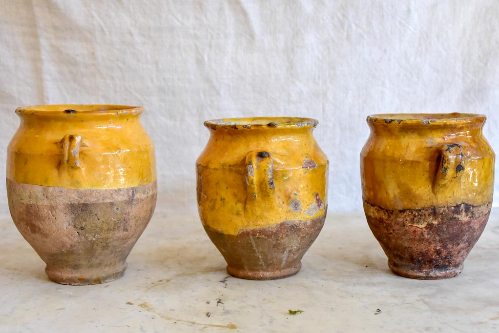 Collection of three very small antique French confit pots with ochre glaze