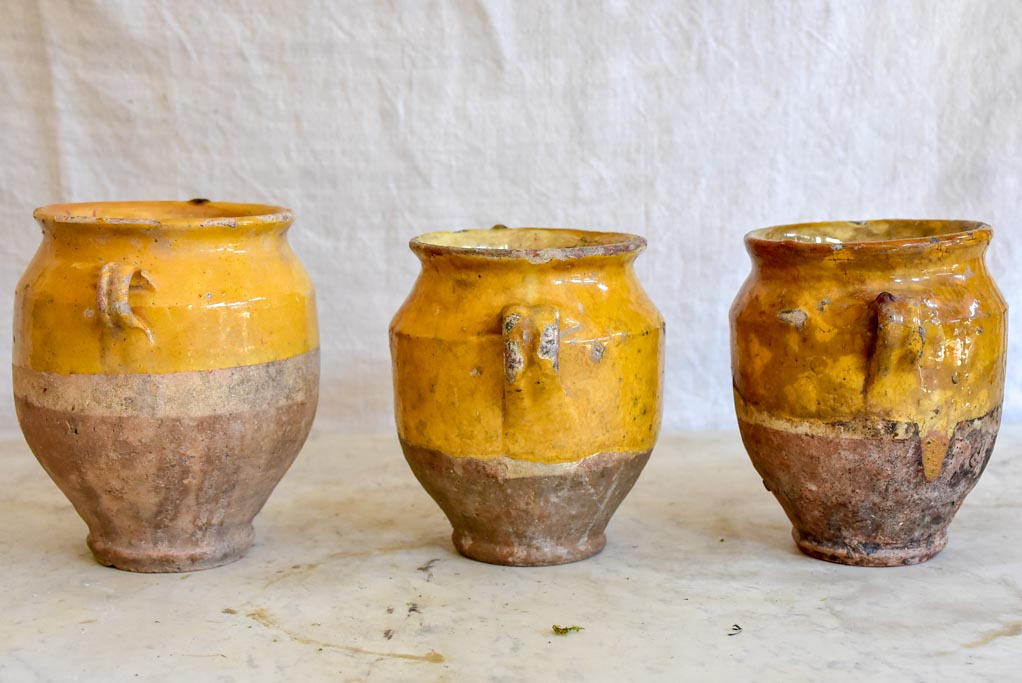 Collection of three very small antique French confit pots with ochre glaze