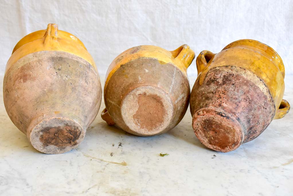 Collection of three very small antique French confit pots with ochre glaze