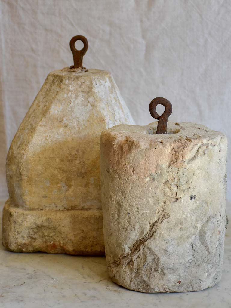 Two antique French stone counterweights