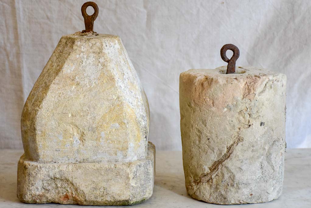 Two antique French stone counterweights