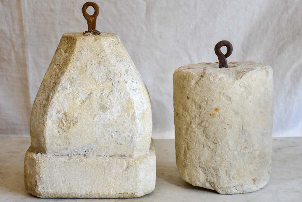 Two antique French stone counterweights