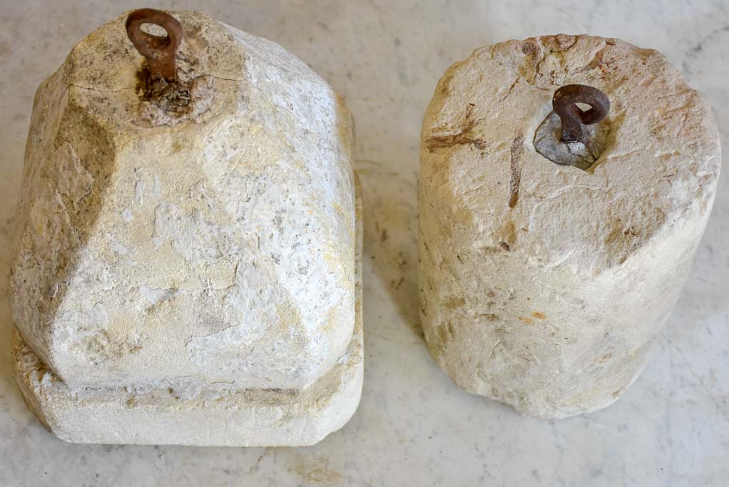 Two antique French stone counterweights