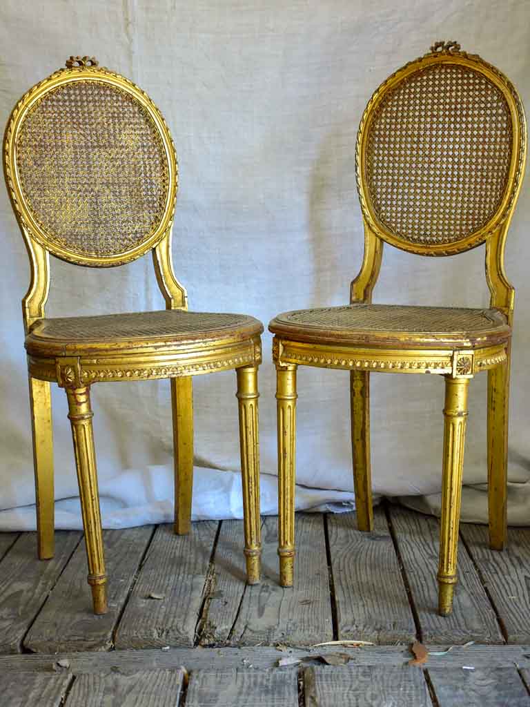 Pair of 18th Century Louis XVI gilded cane chairs