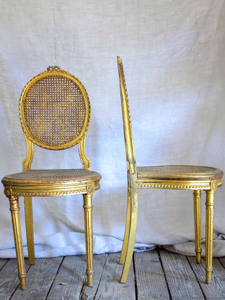 Pair of 18th Century Louis XVI gilded cane chairs